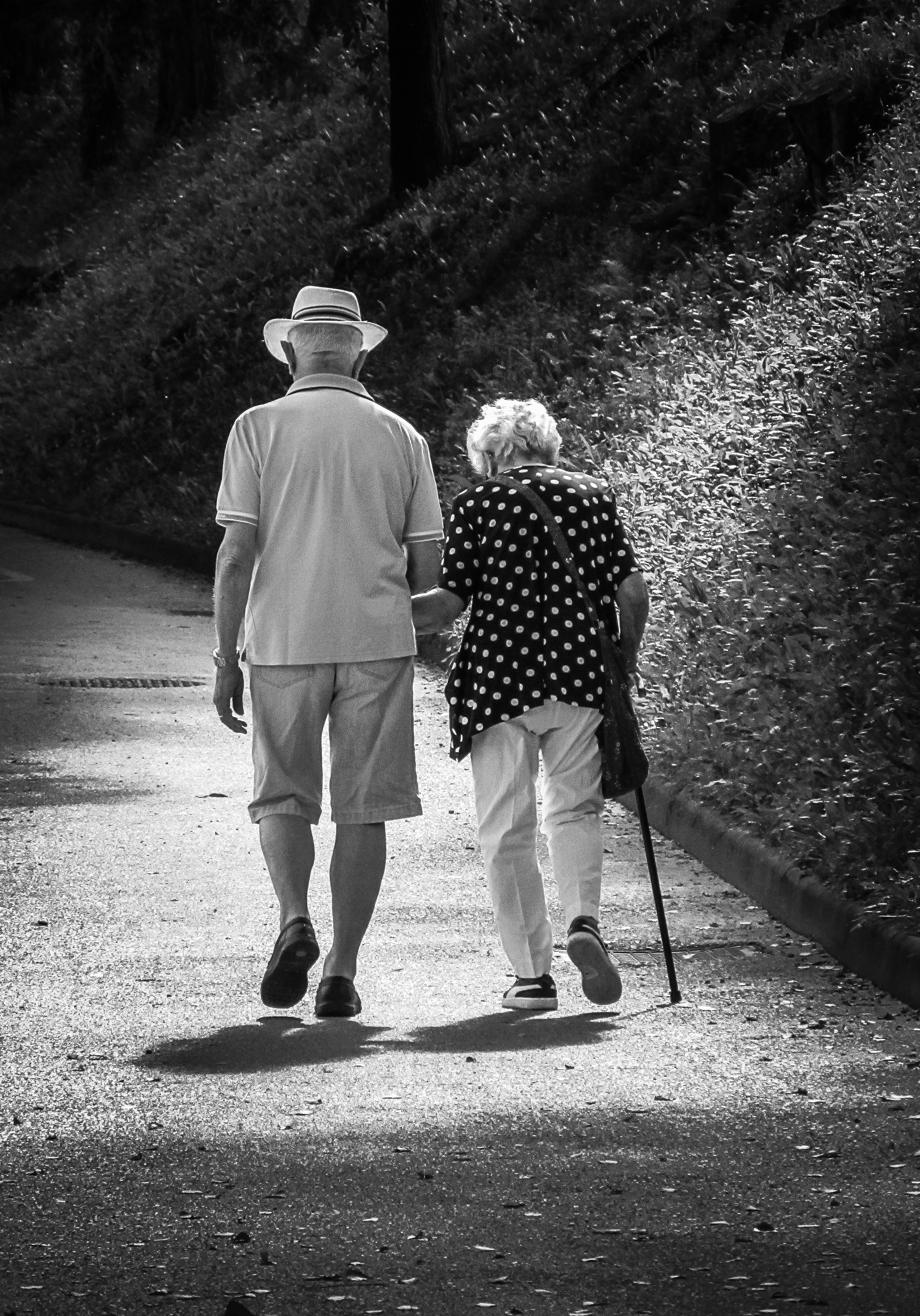 A man and a woman walking down a path