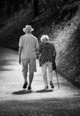 A man and a woman walking down a path