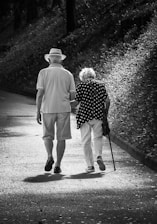 A man and a woman walking down a path