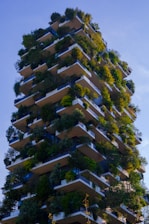 A very tall building with lots of plants growing on it