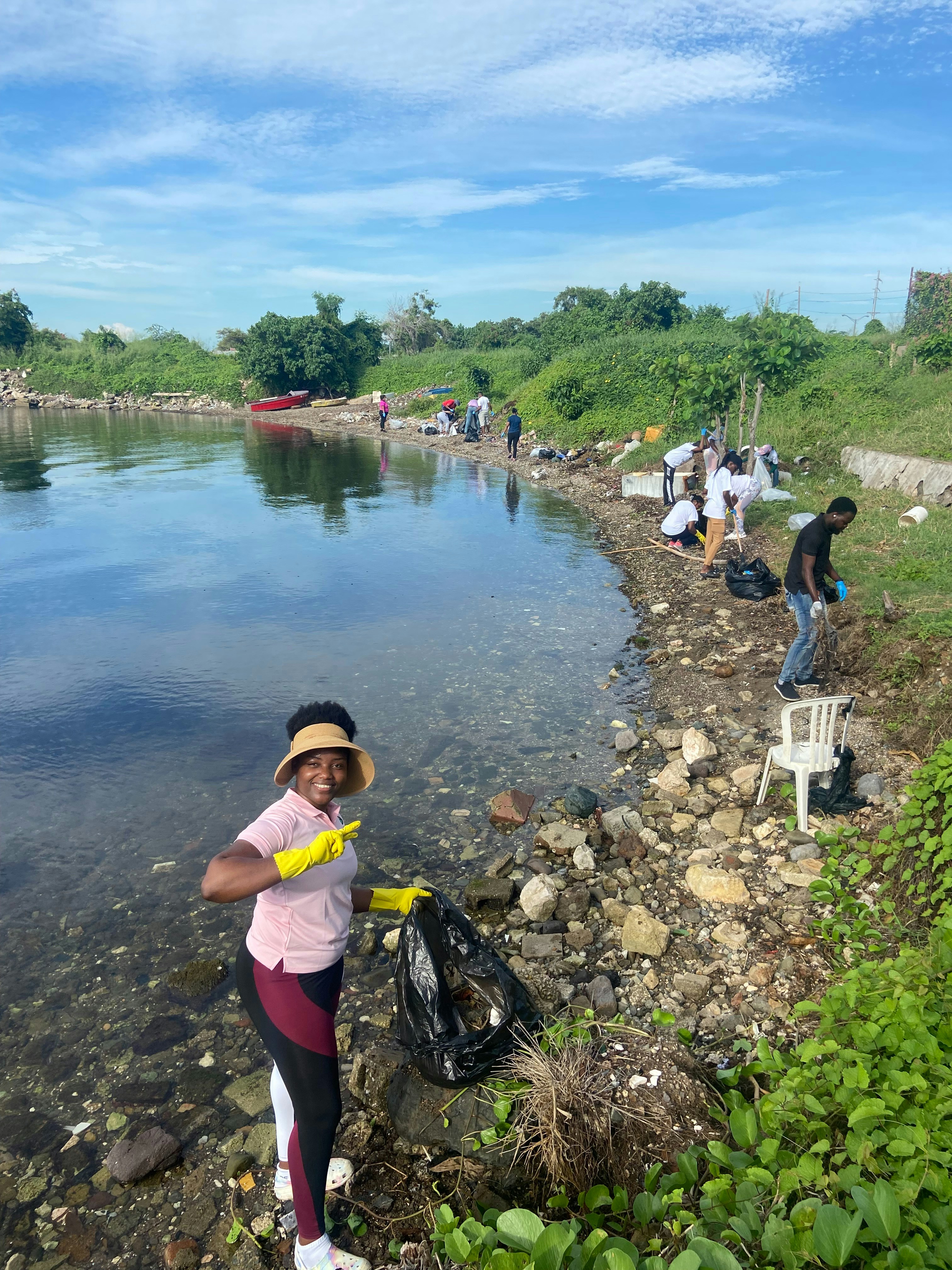 Environmental activists cleaning polluted shoreline with gloves and bags