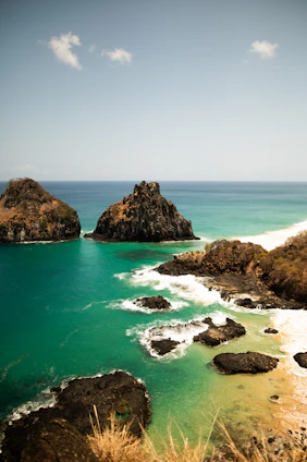 A view of a body of water with rocks in the foreground