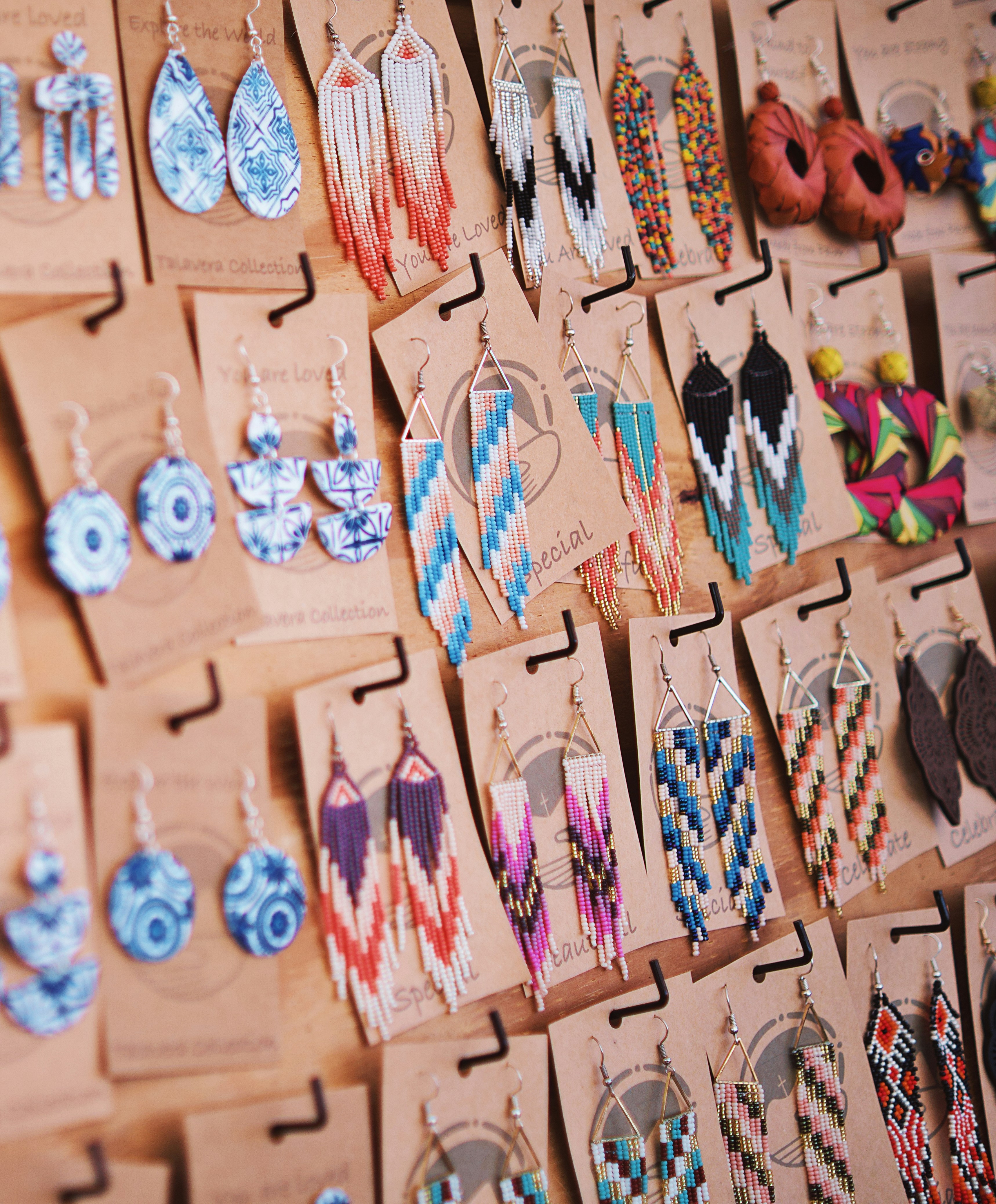 A bunch of earrings are hanging on a wall