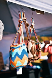 A couple of bags hanging from a hook