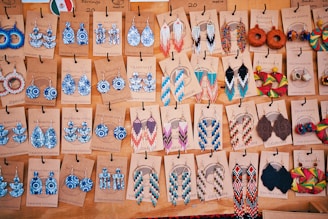 A table topped with lots of different types of earrings