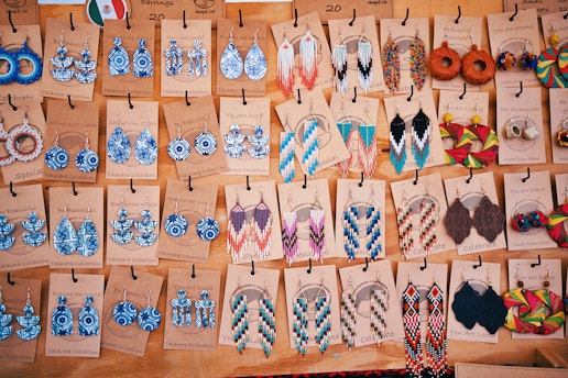 A table topped with lots of different types of earrings