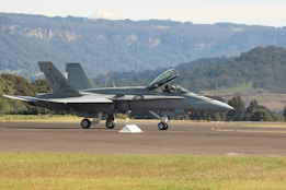 A fighter jet sitting on top of an airport runway