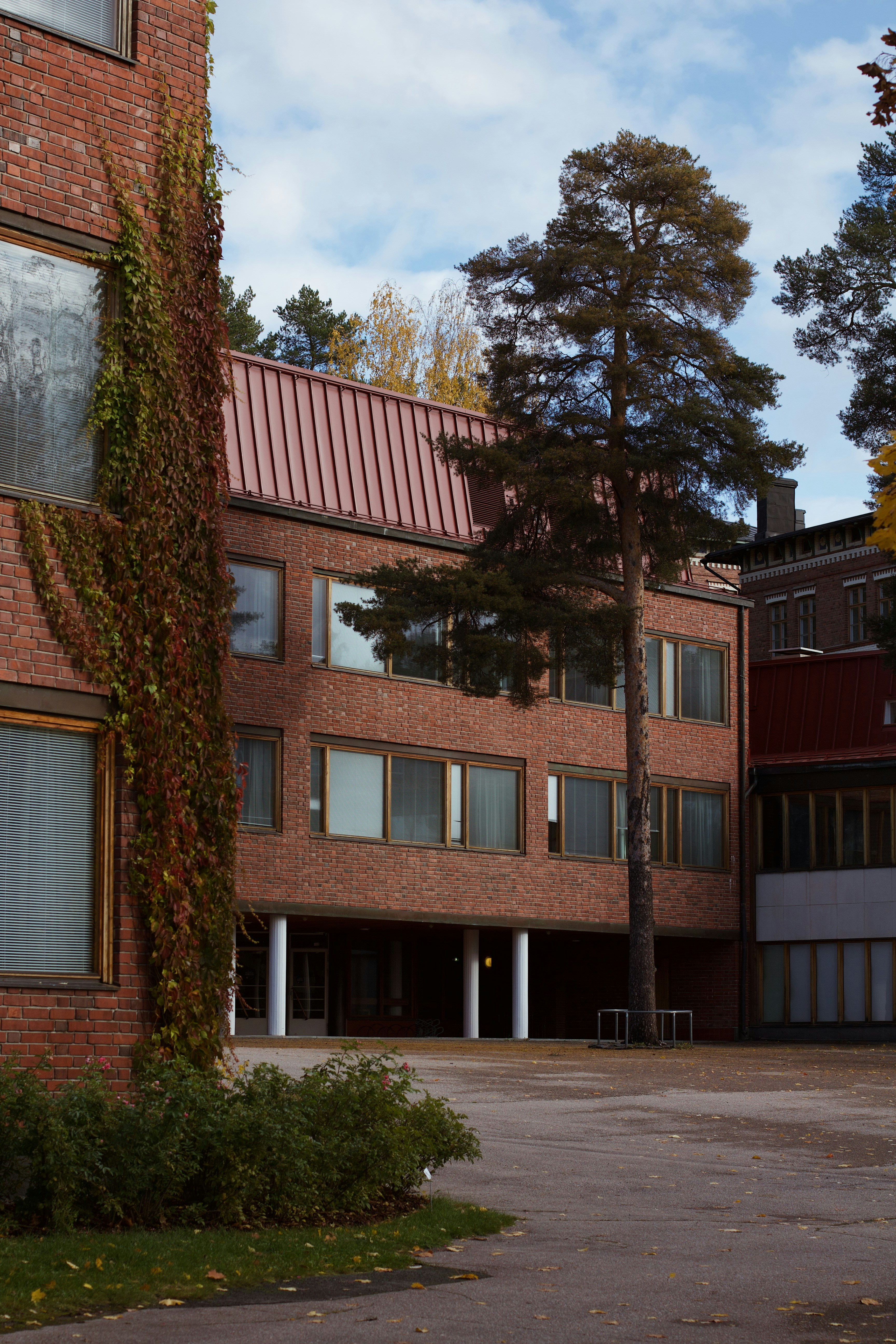 A brick building with a parking lot in front of it