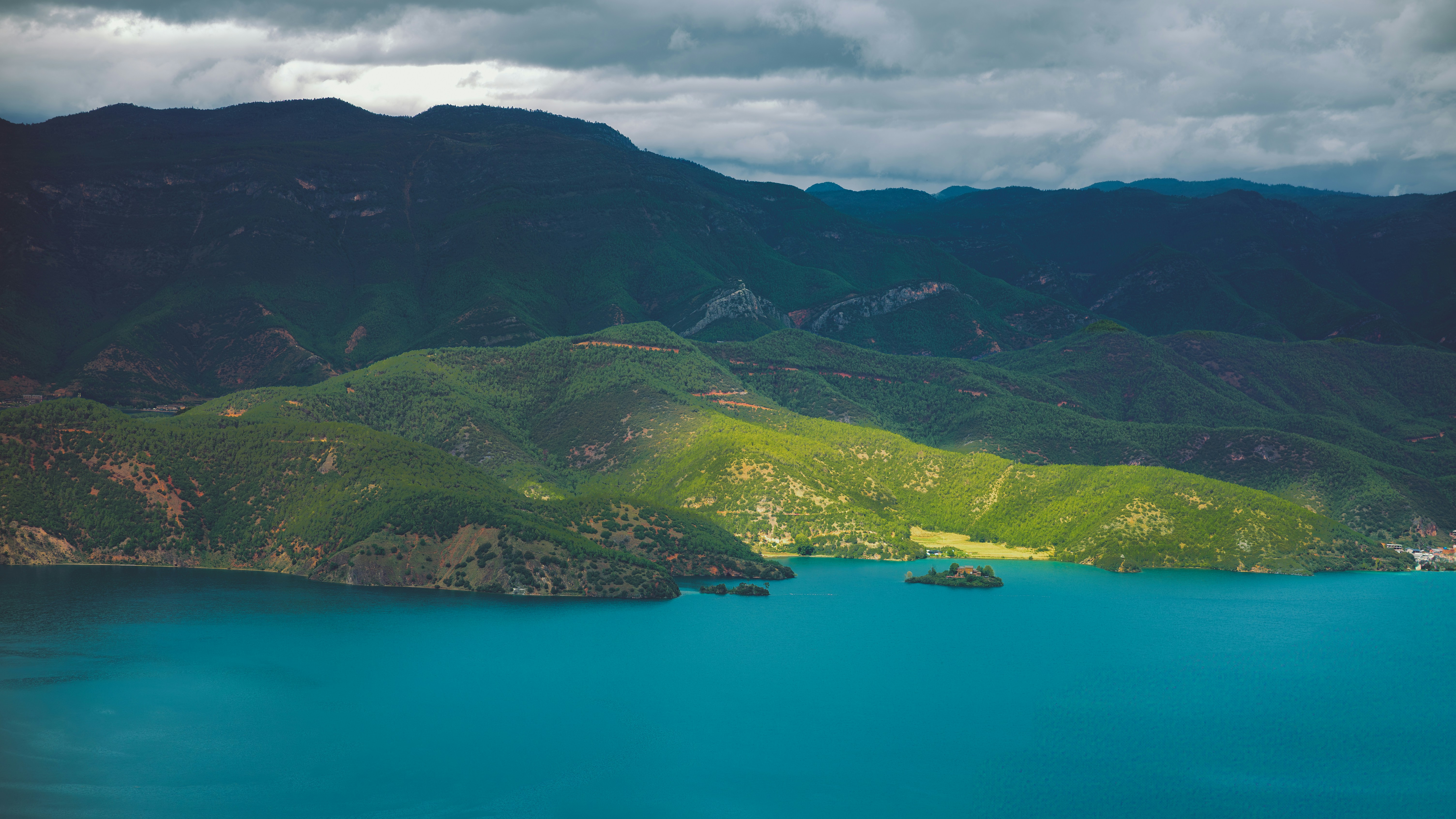 a-large-body-of-water-surrounded-by-mountains-photo-free-land-image