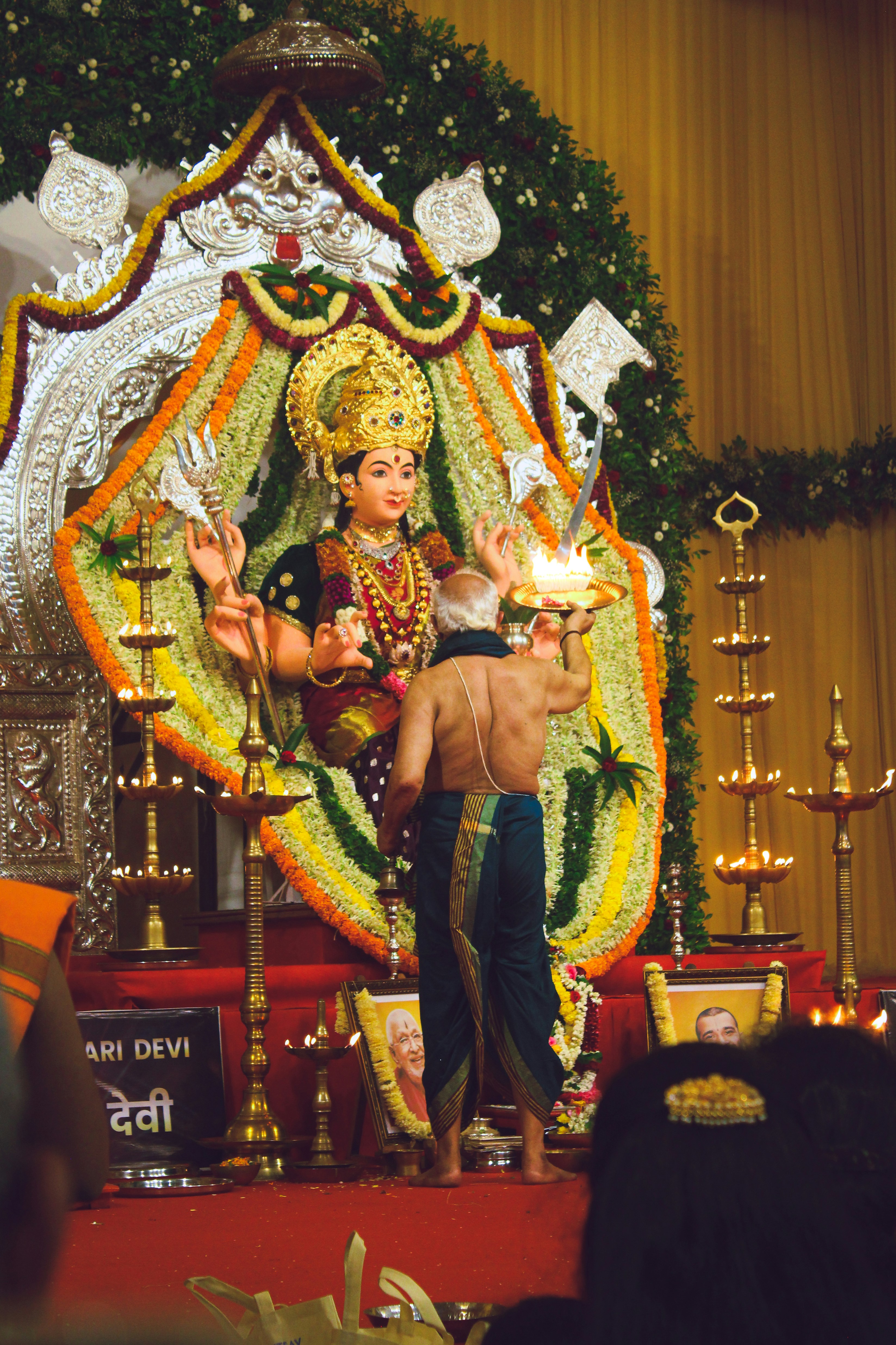 A statue of a person holding a lit candle