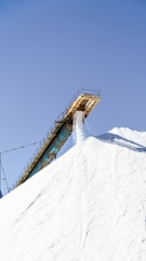 A man riding a snowboard down the side of a snow covered slope