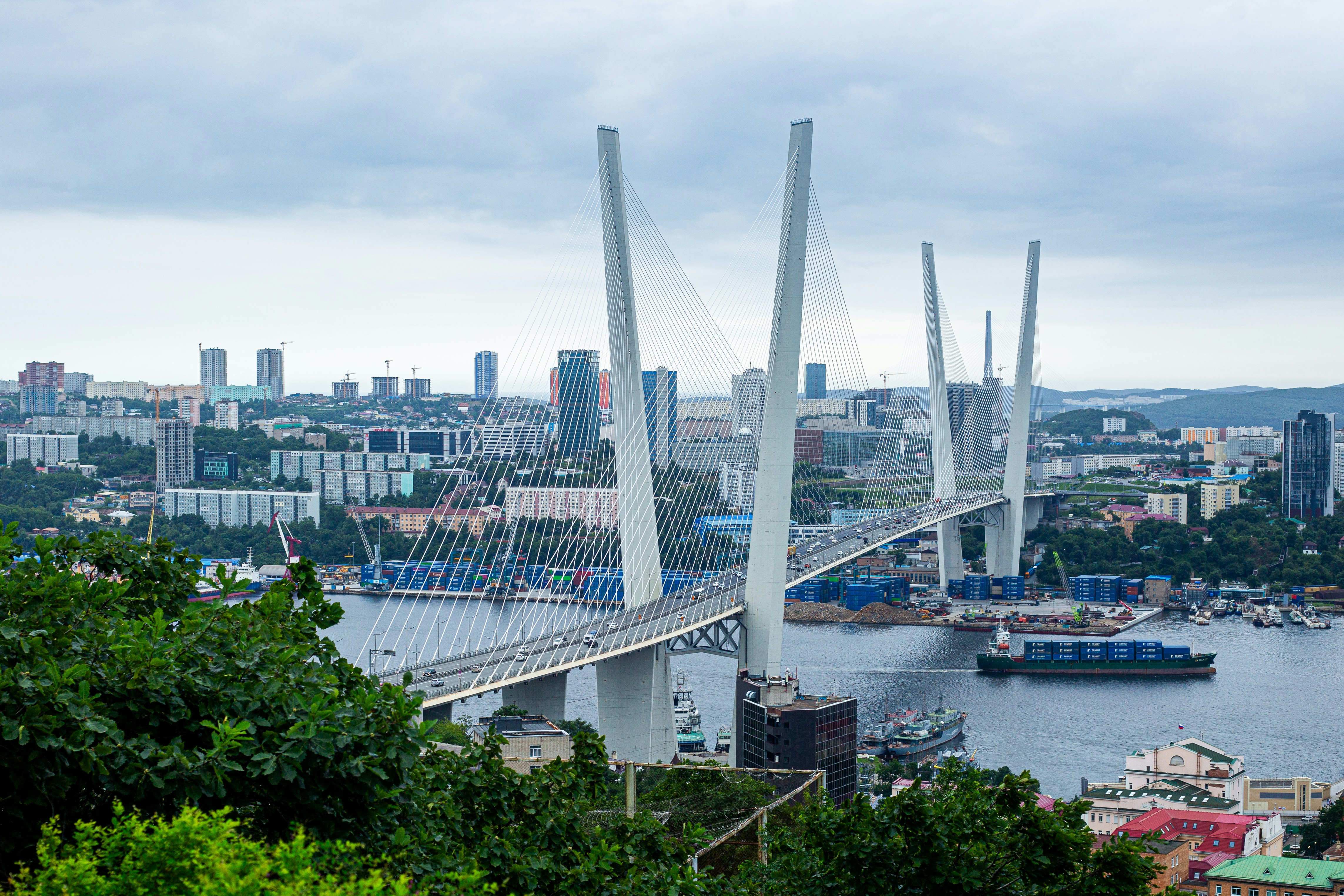 A view of a bridge over a river with a city in the background
