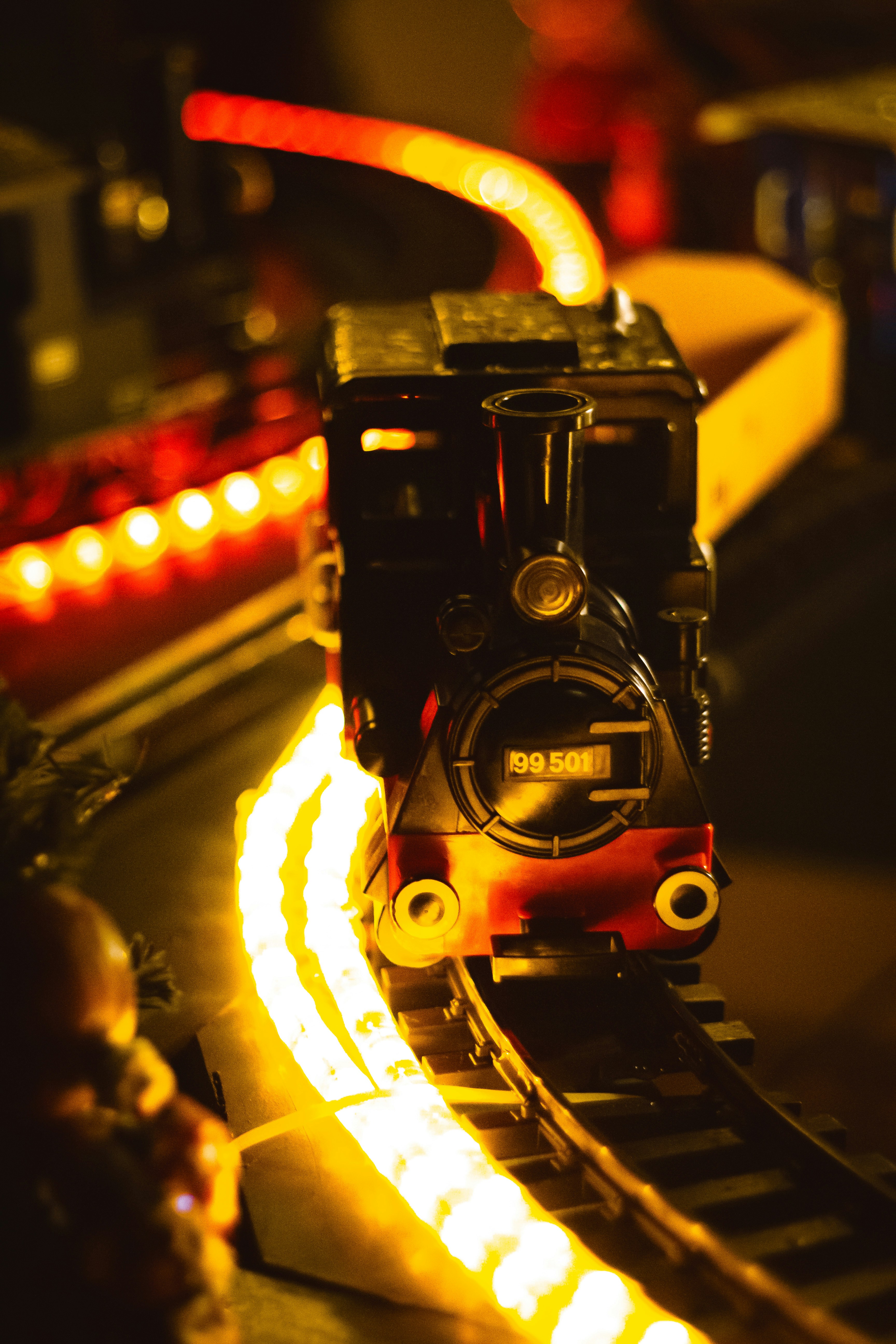 A toy train on a track with lights