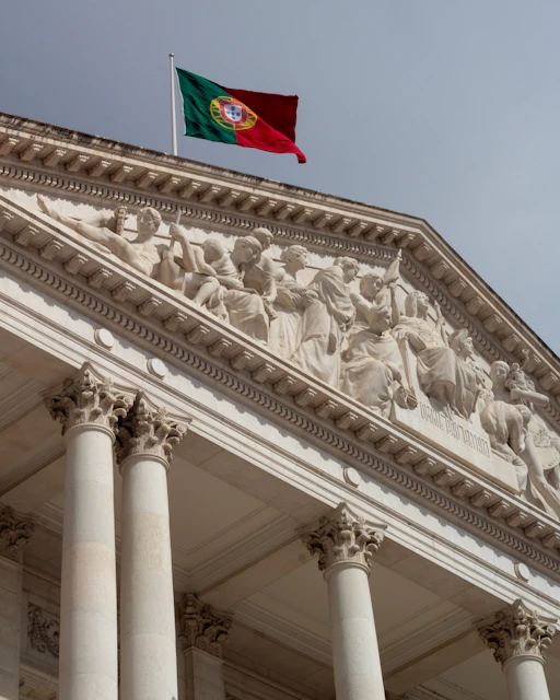 A building with columns and a flag on top of it