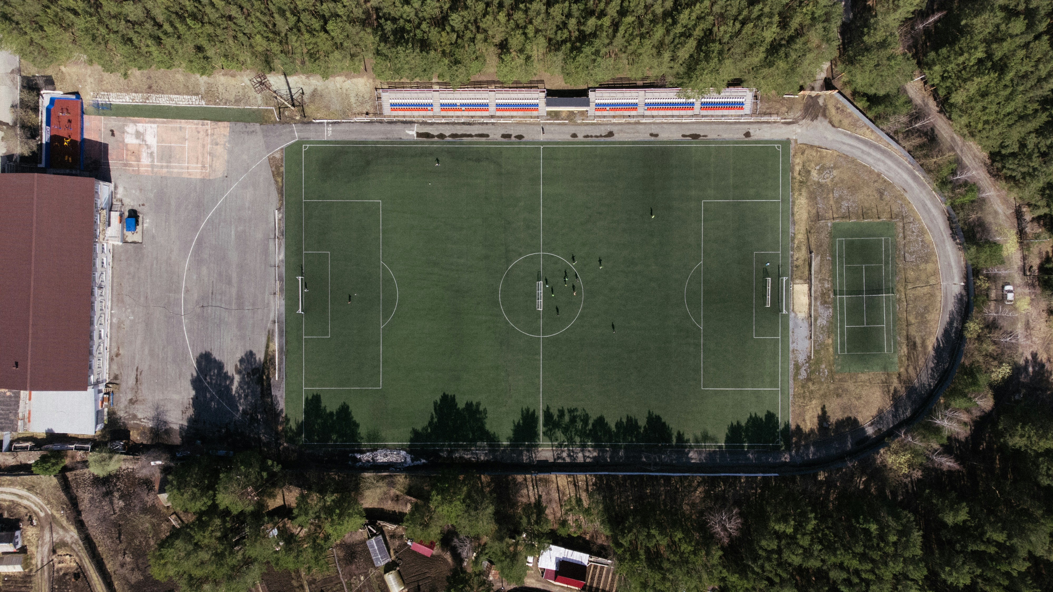 An aerial view of a soccer field in the woods