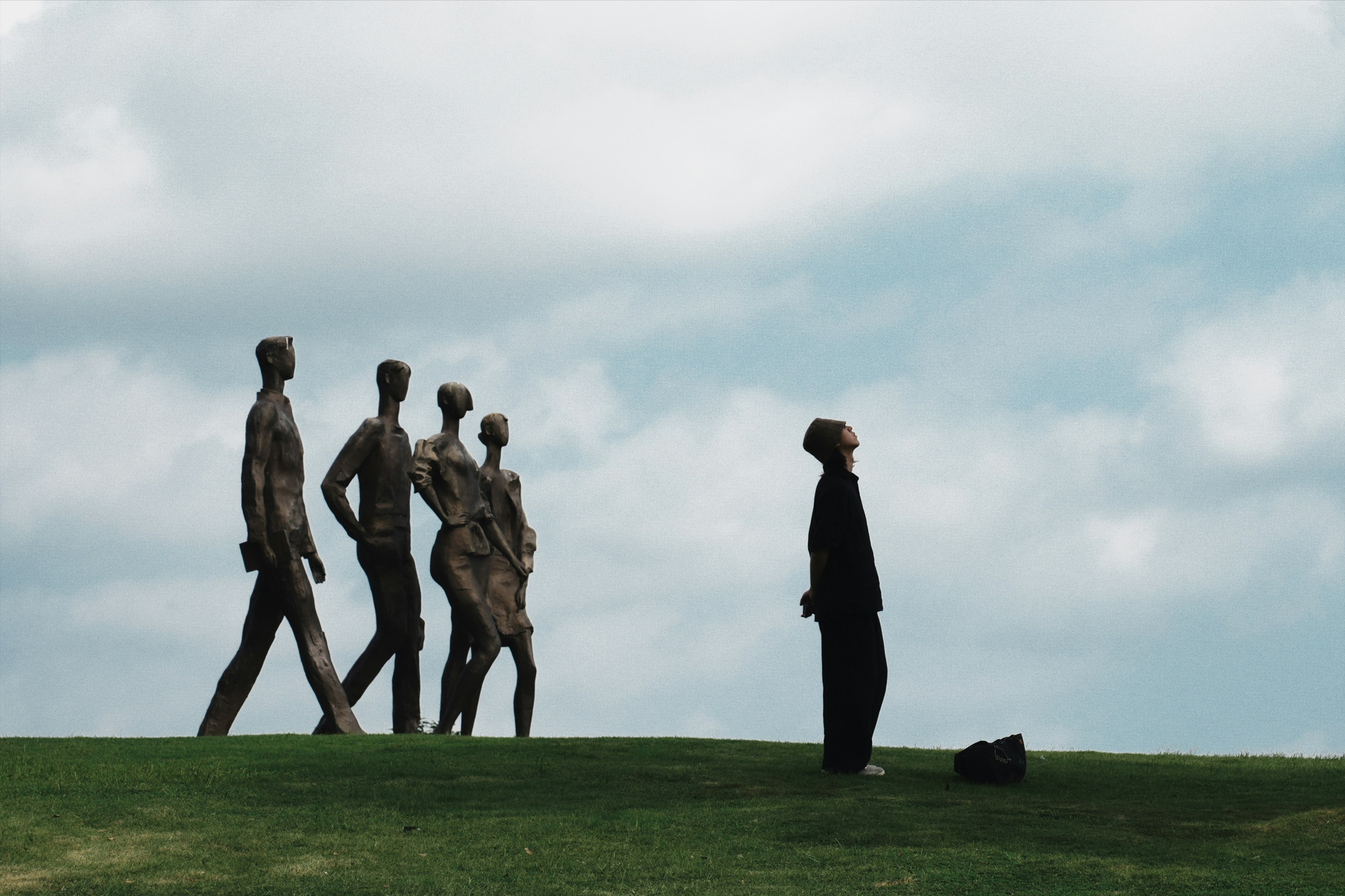 A group of people walking across a lush green field