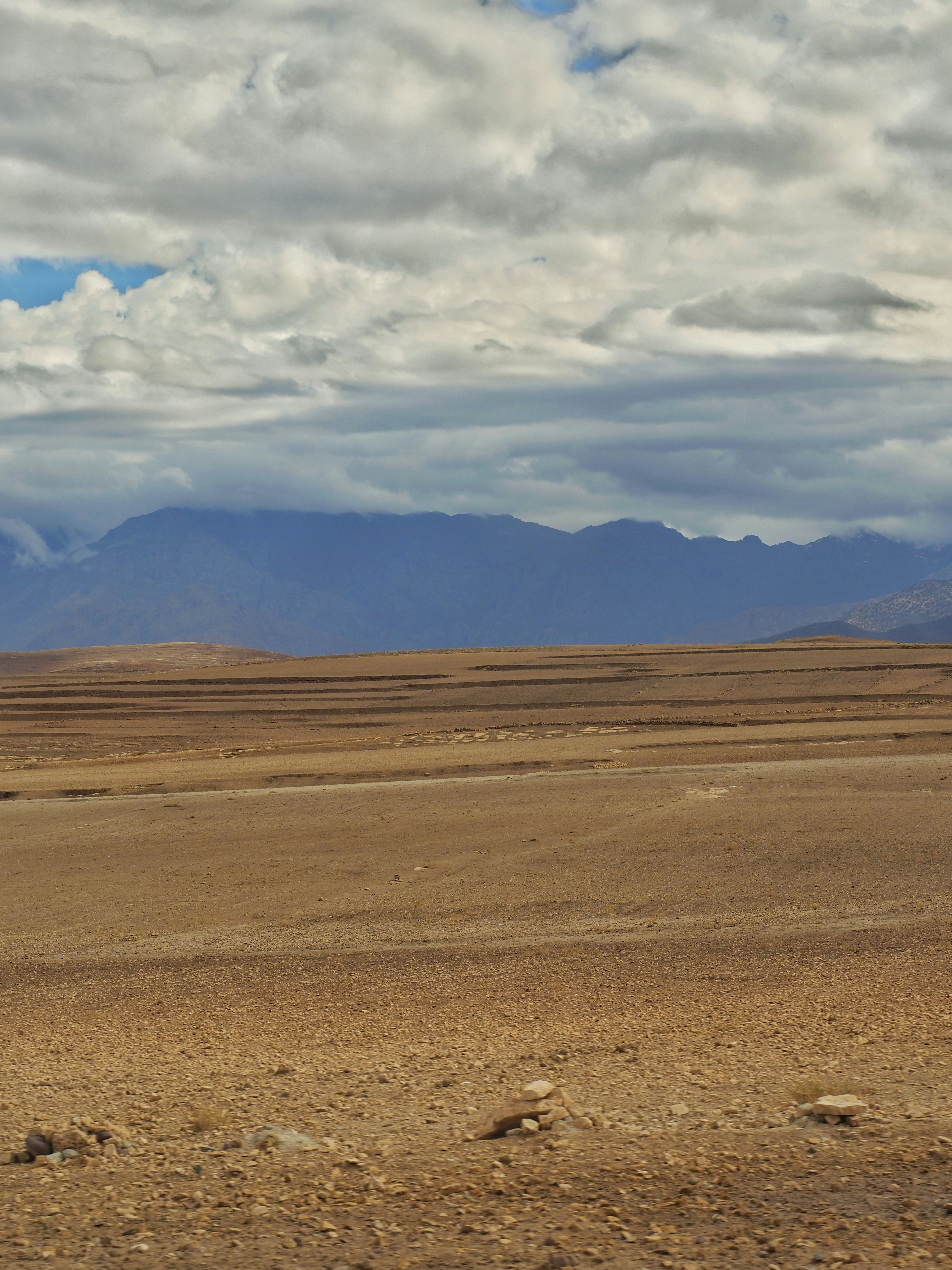 A man riding a horse across a desert plain