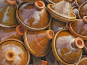A pile of brown pots sitting next to each other