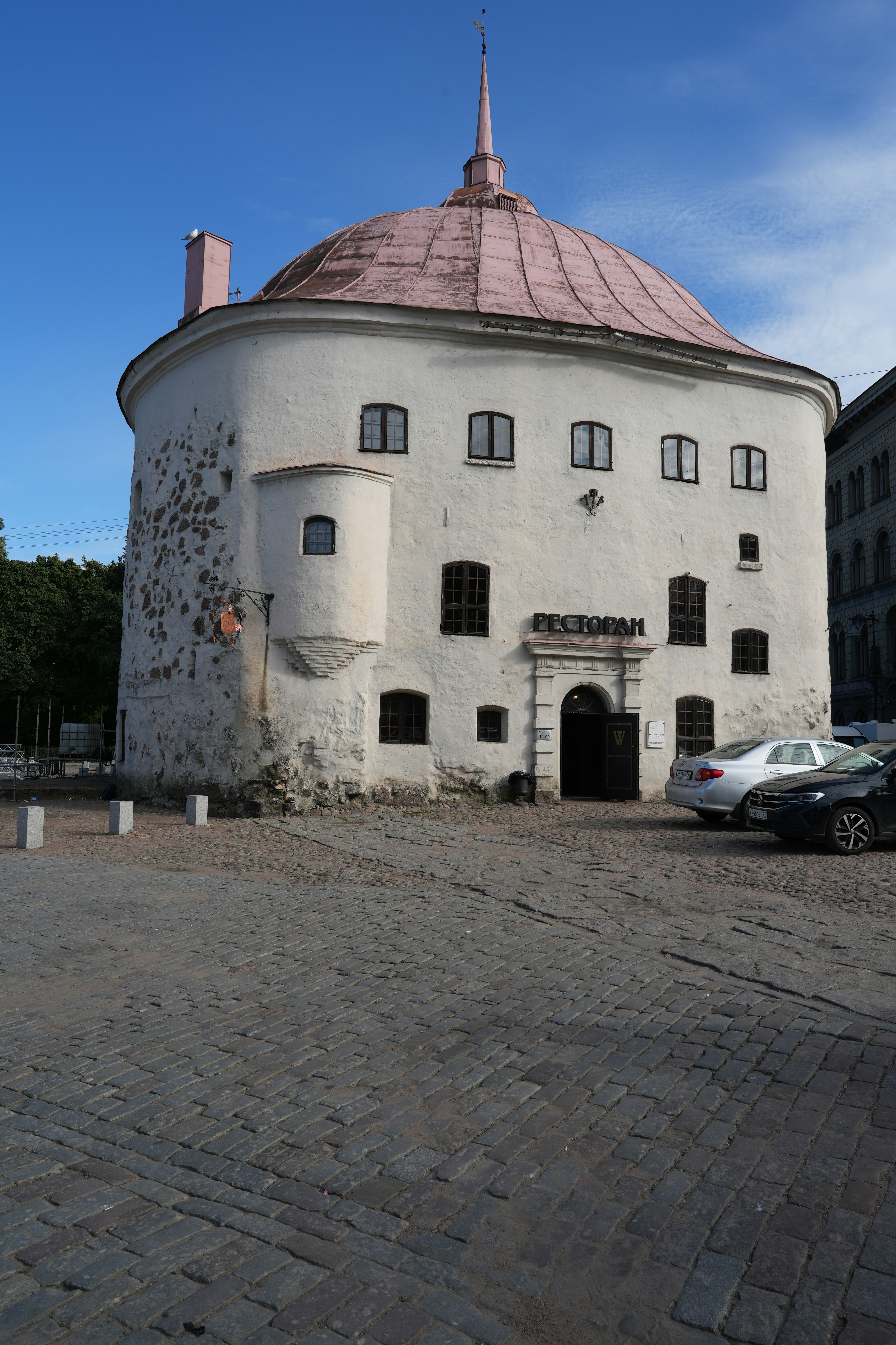A large white building with a pink roof