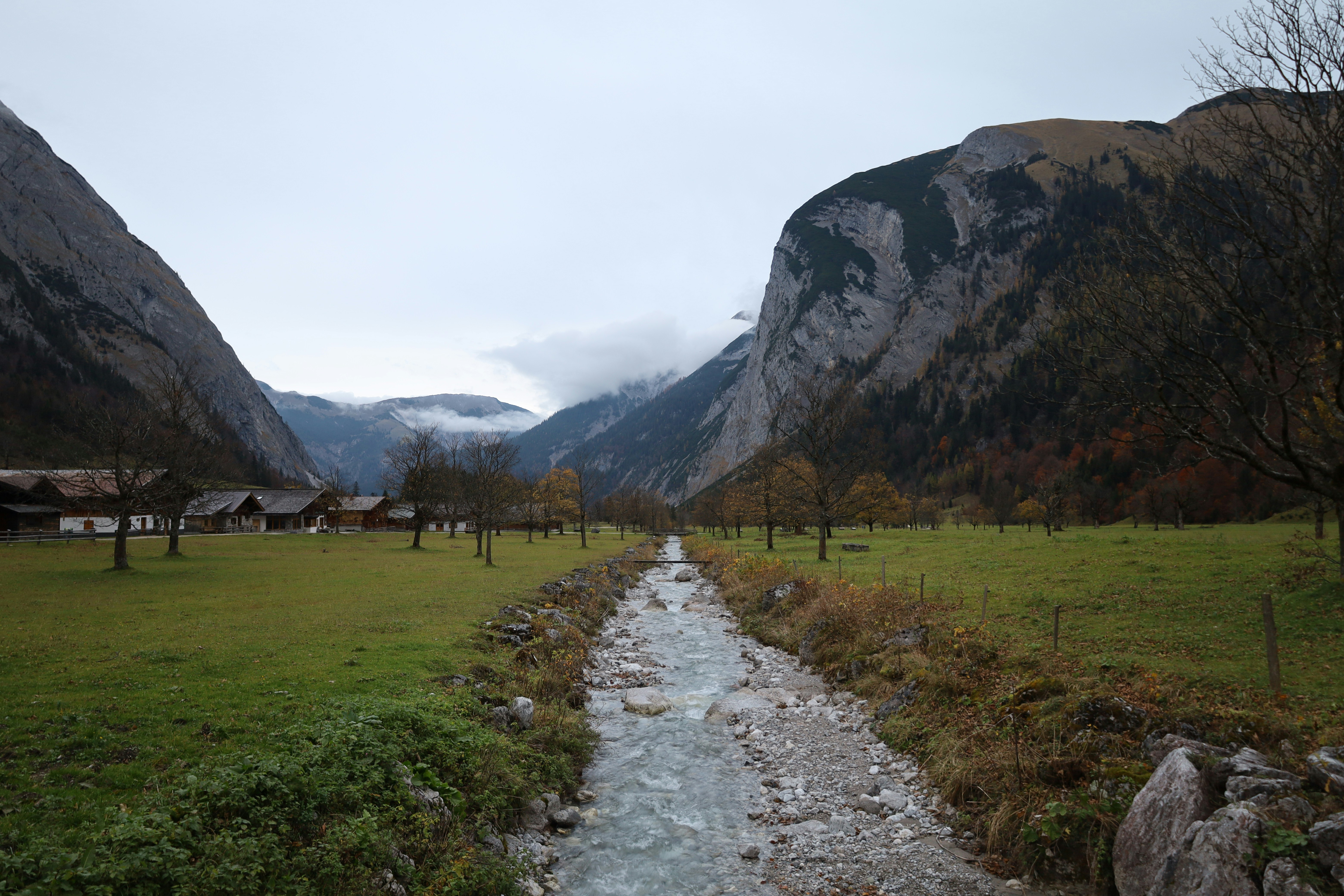 A stream running through a lush green valley