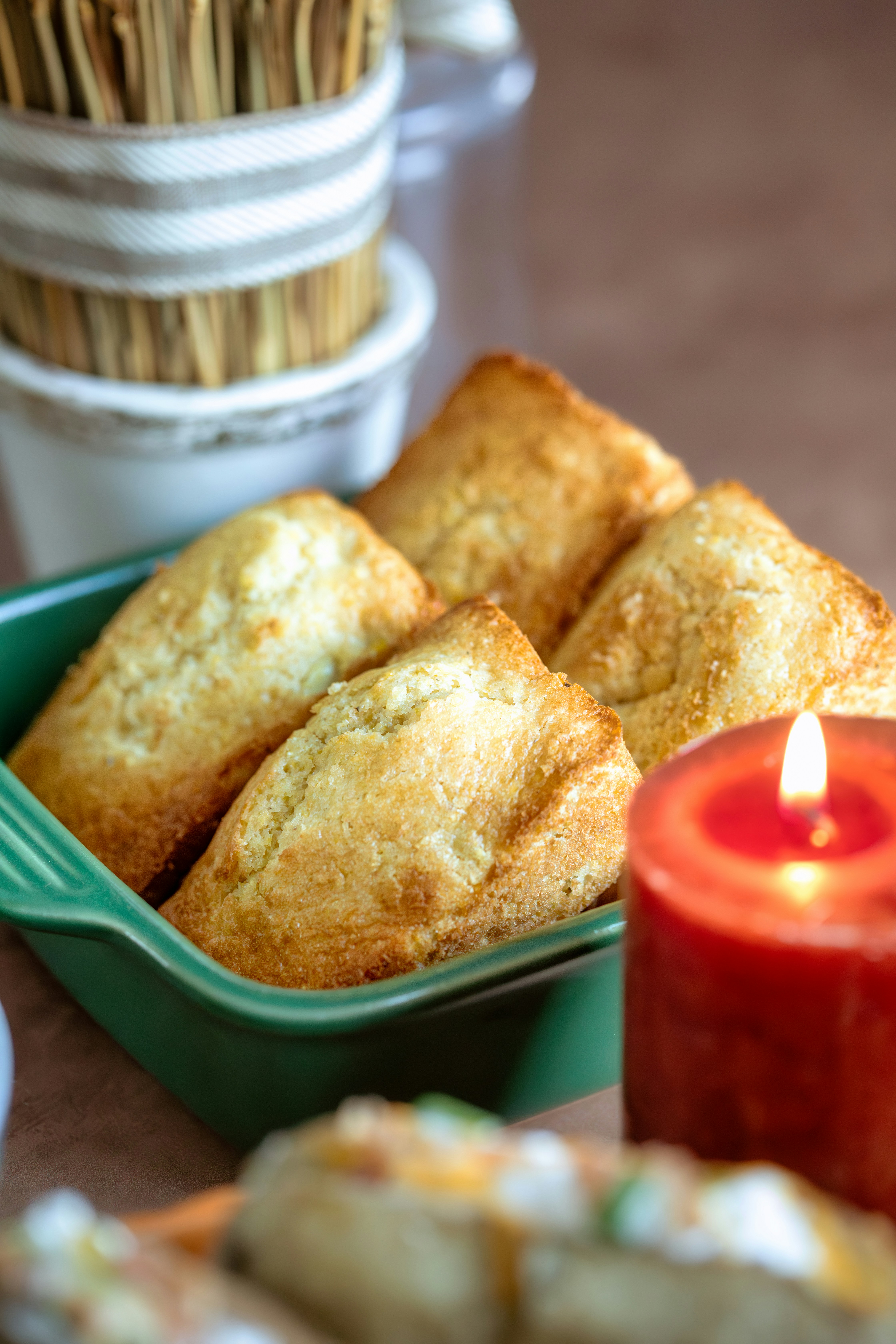 A table topped with plates of food and a candle