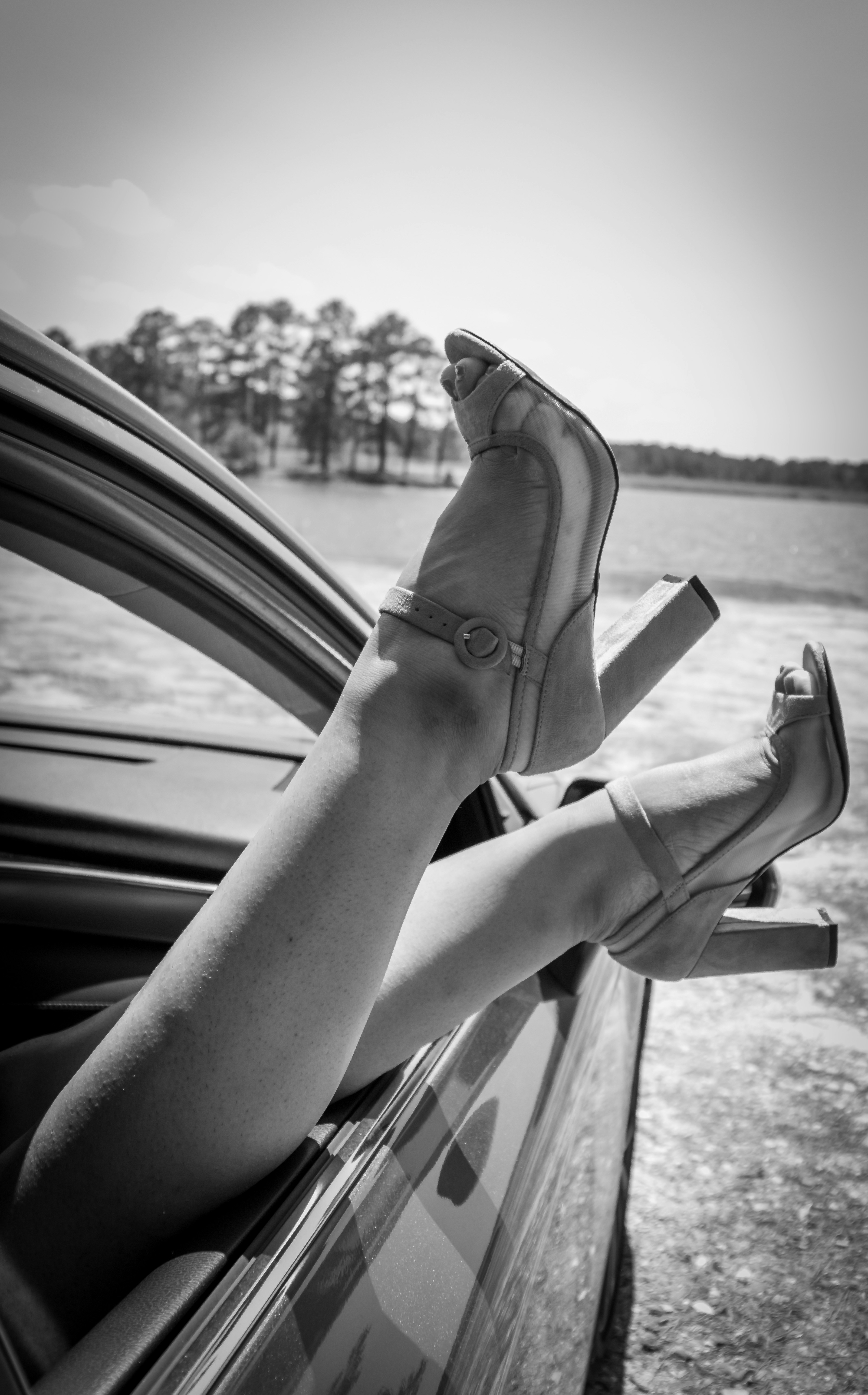 A woman's legs sticking out of a car window