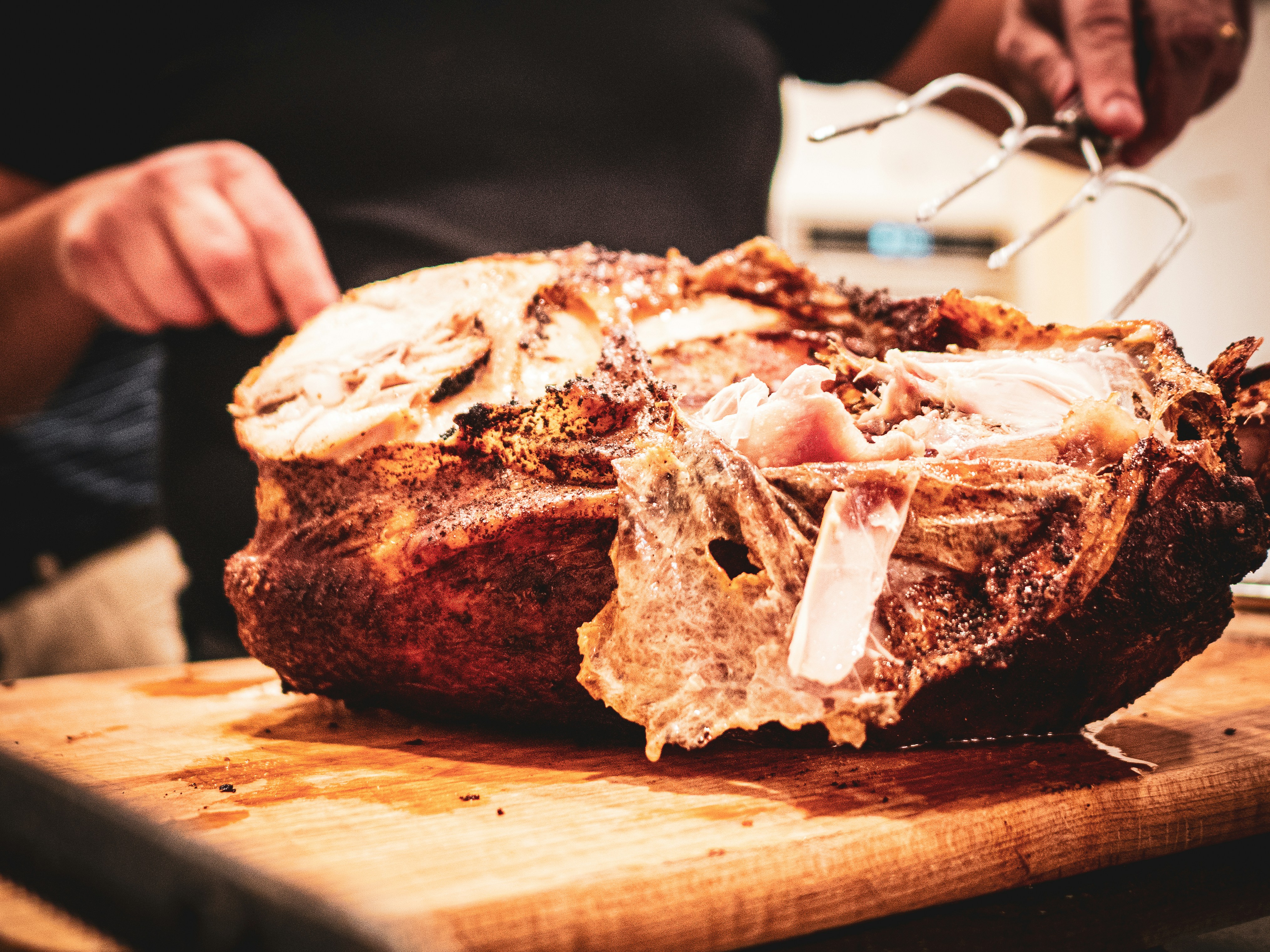 A person cutting meat on a cutting board