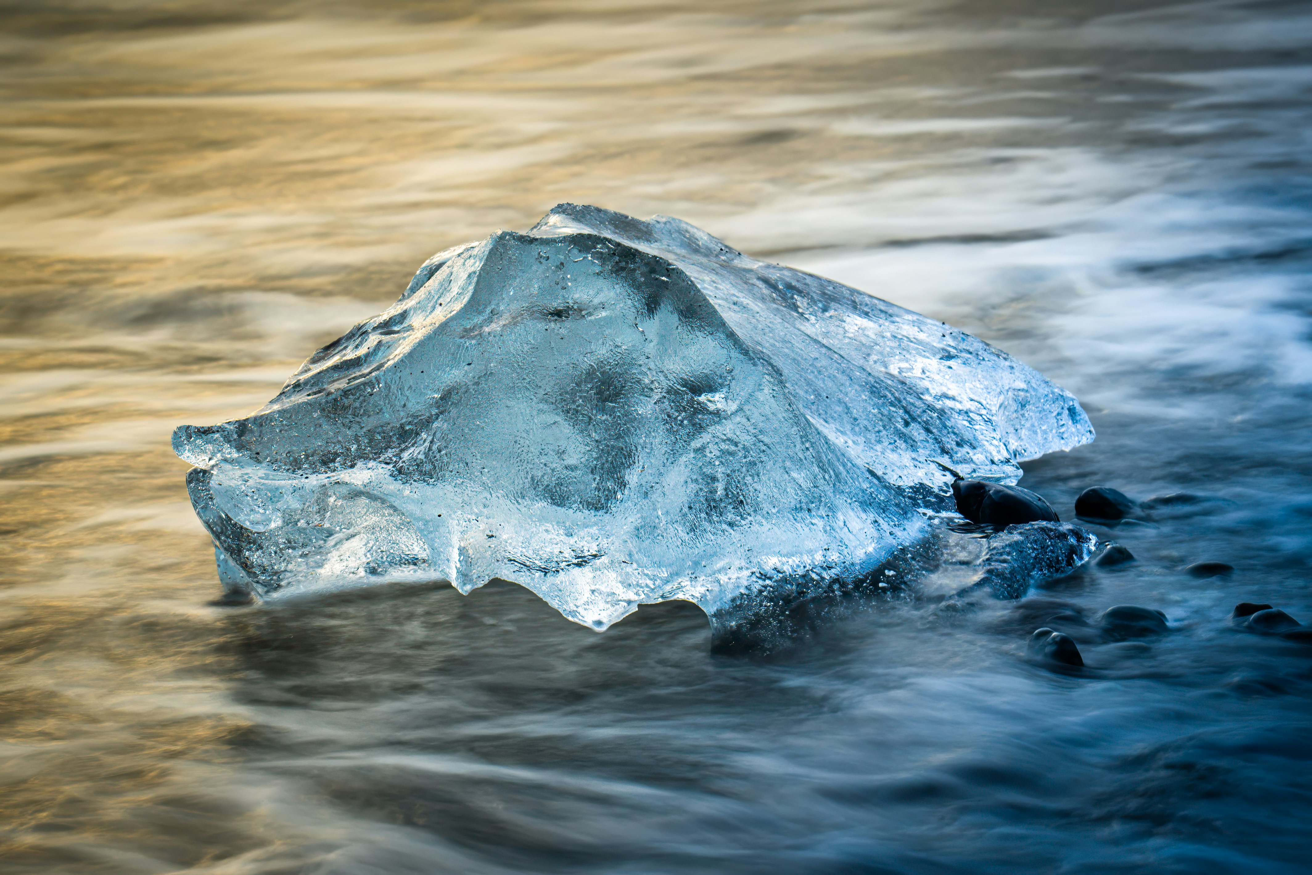 An iceberg floating in a body of water