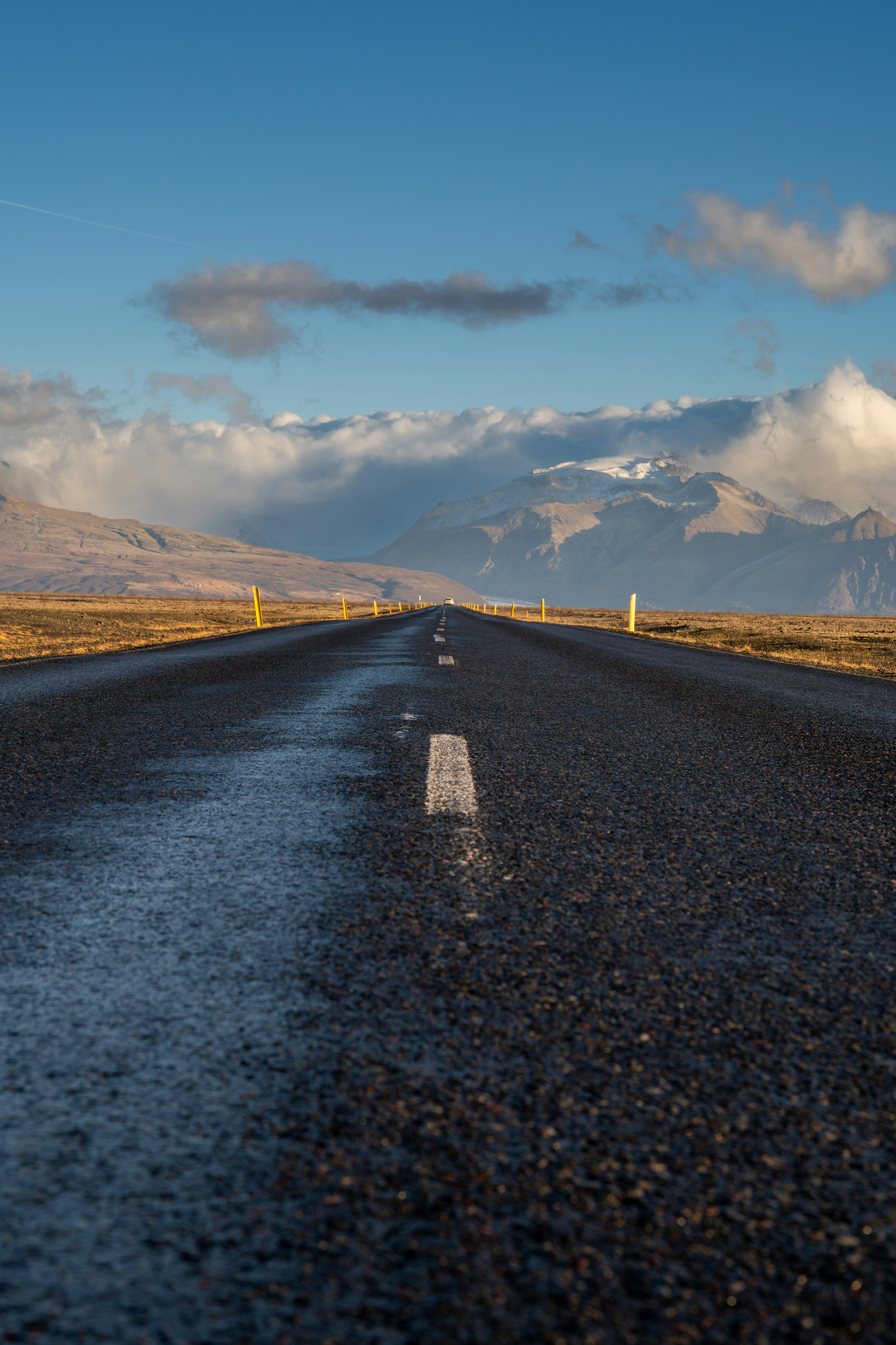 An empty road with mountains in the background