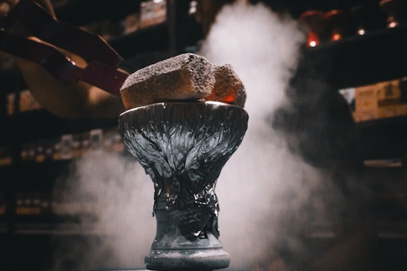 A close up of a vase with smoke coming out of it