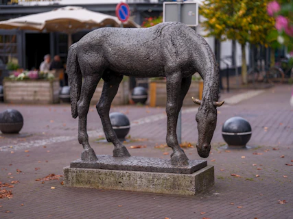 A statue of a horse on a city street