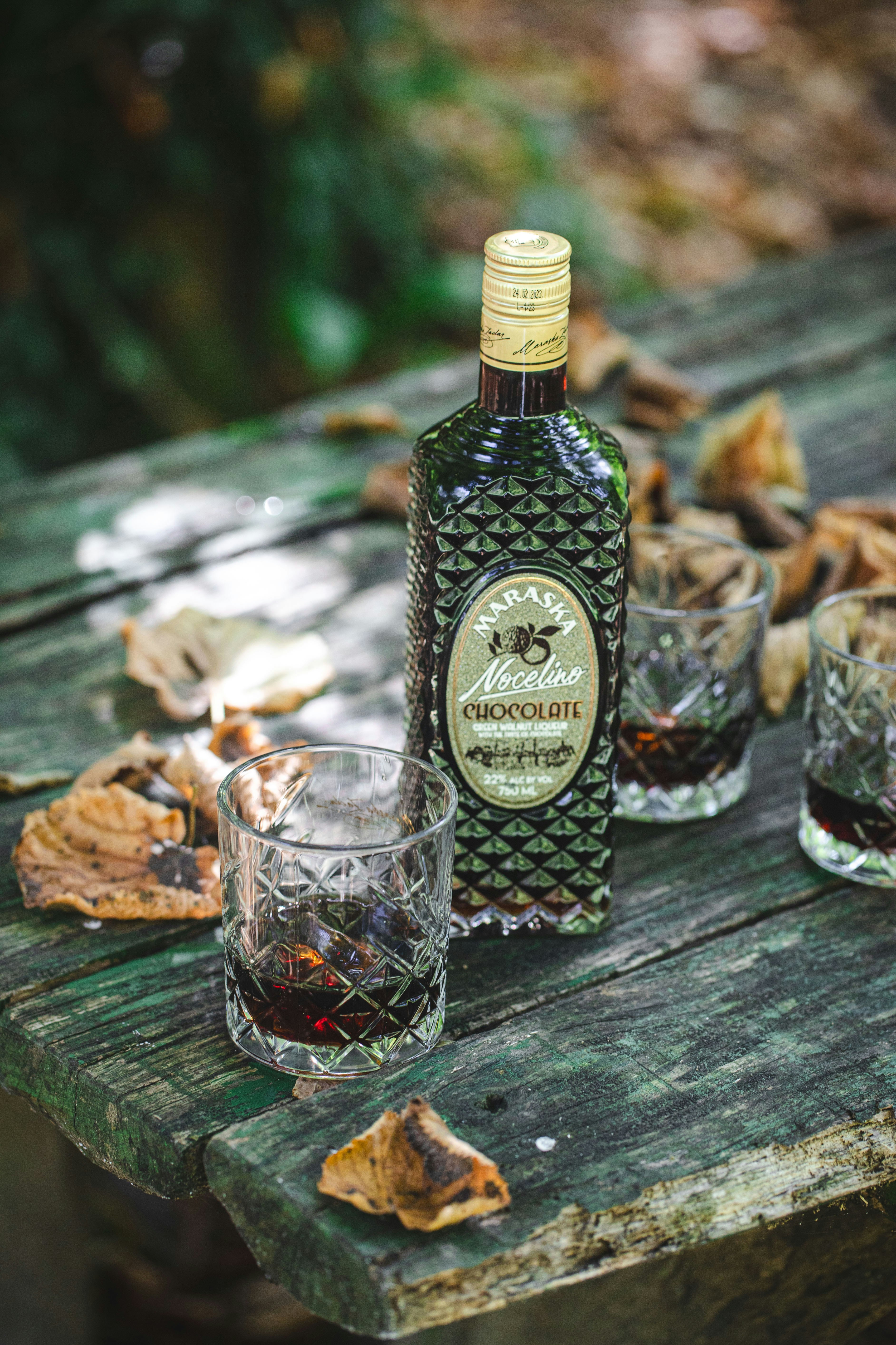 A bottle of liquor sitting on top of a wooden table