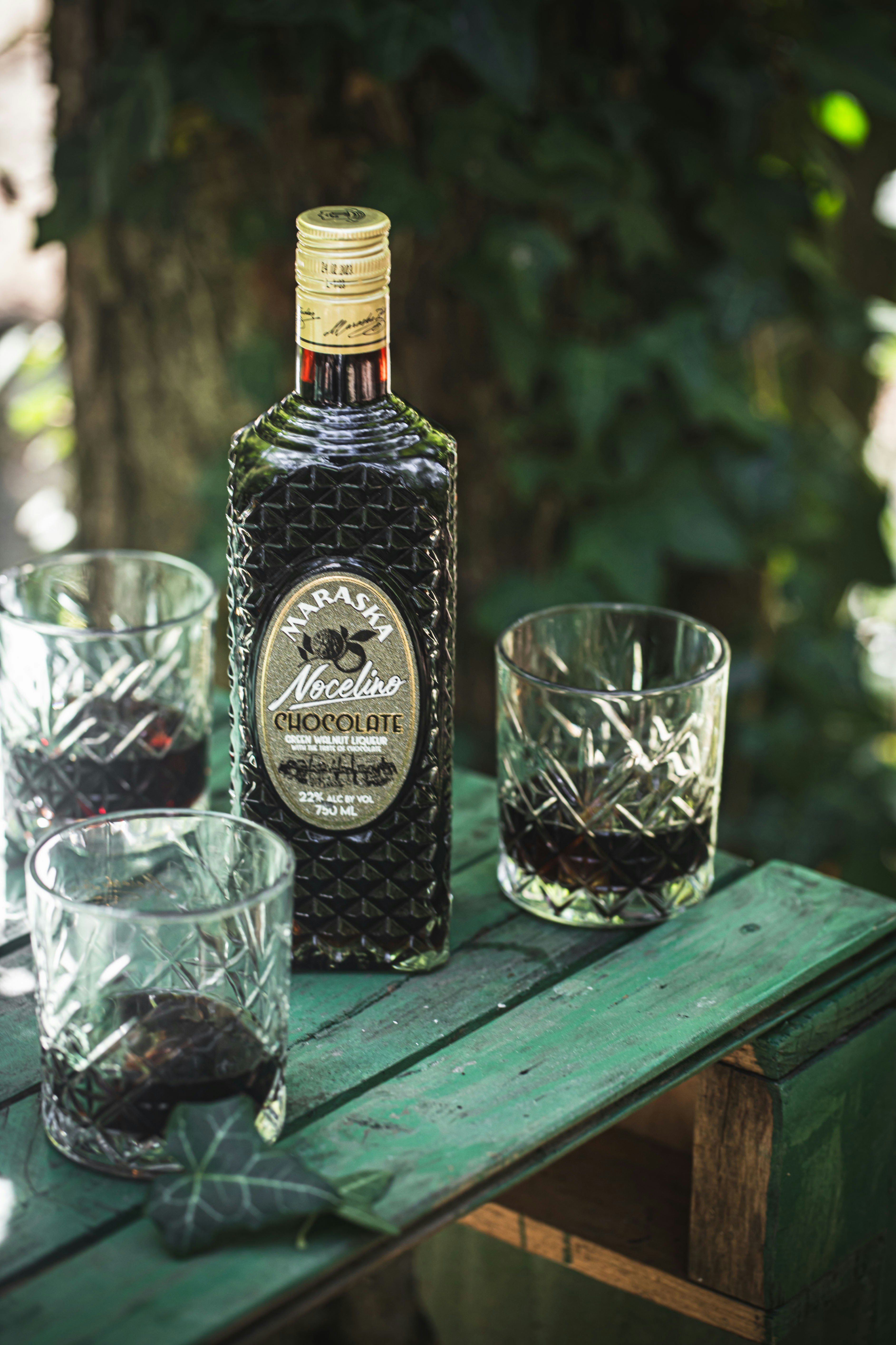 A bottle of liquor sitting on top of a wooden table