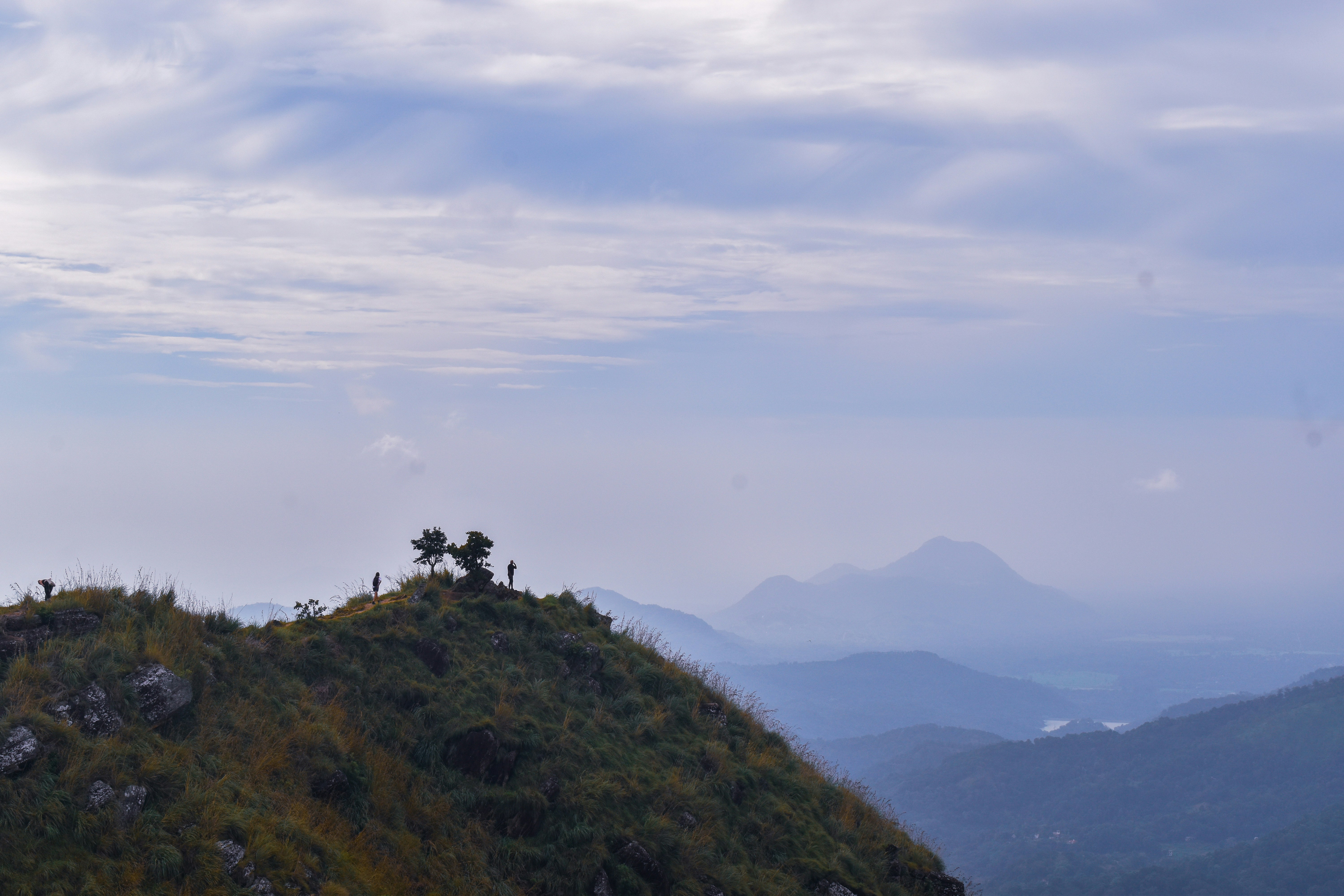 A hill with a cross on top of it