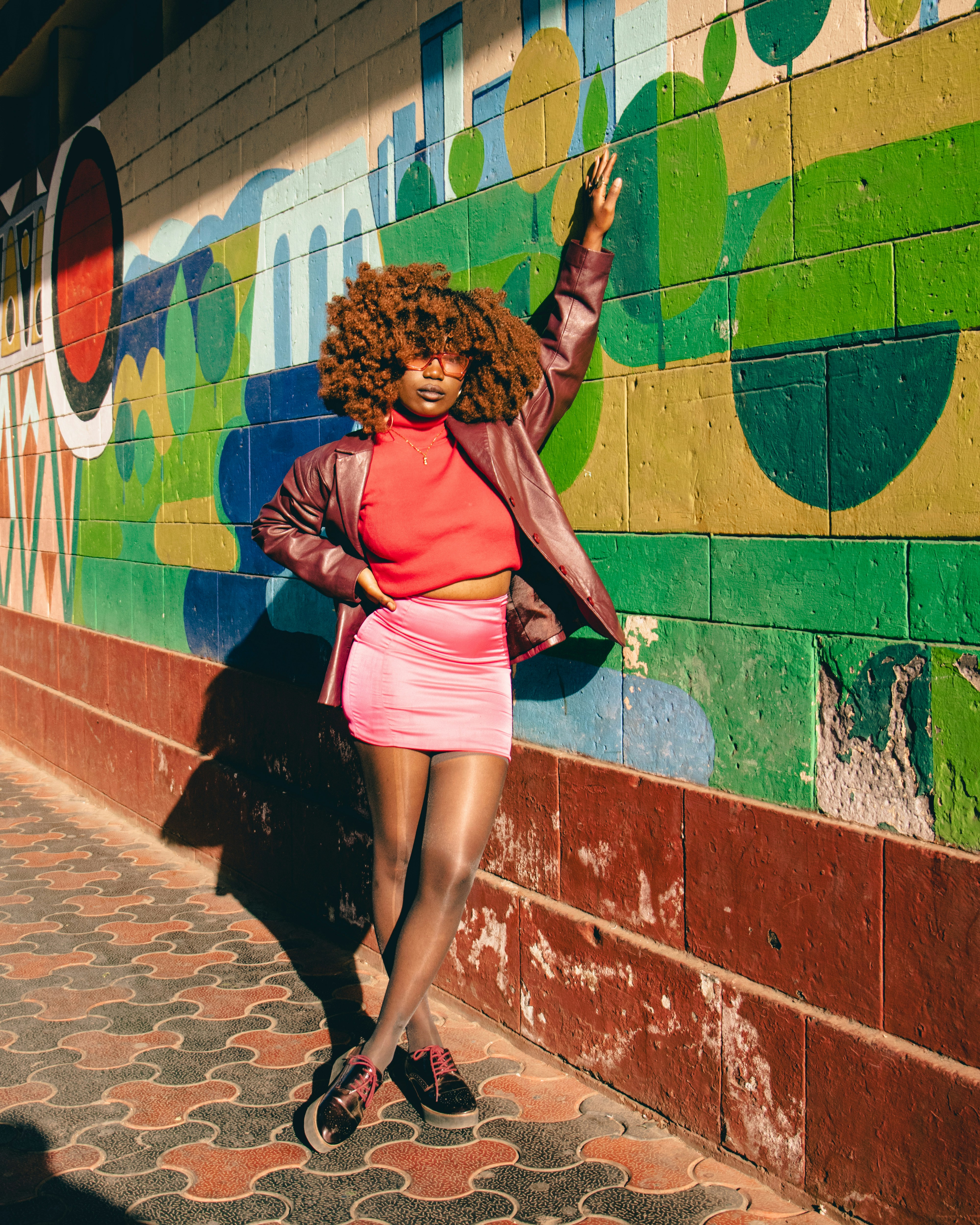 A woman standing in front of a colorful wall