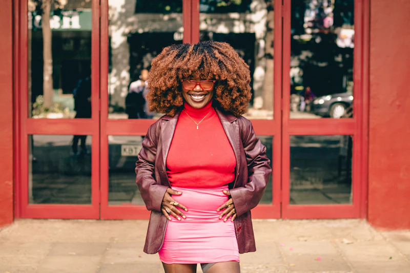 curvy woman standing in front of red building