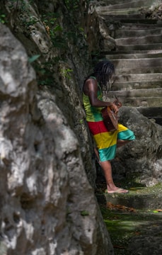 A woman in a colorful dress walking up a set of stairs