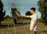 A man standing in front of a painting on a easel