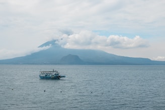A boat floating on top of a large body of water