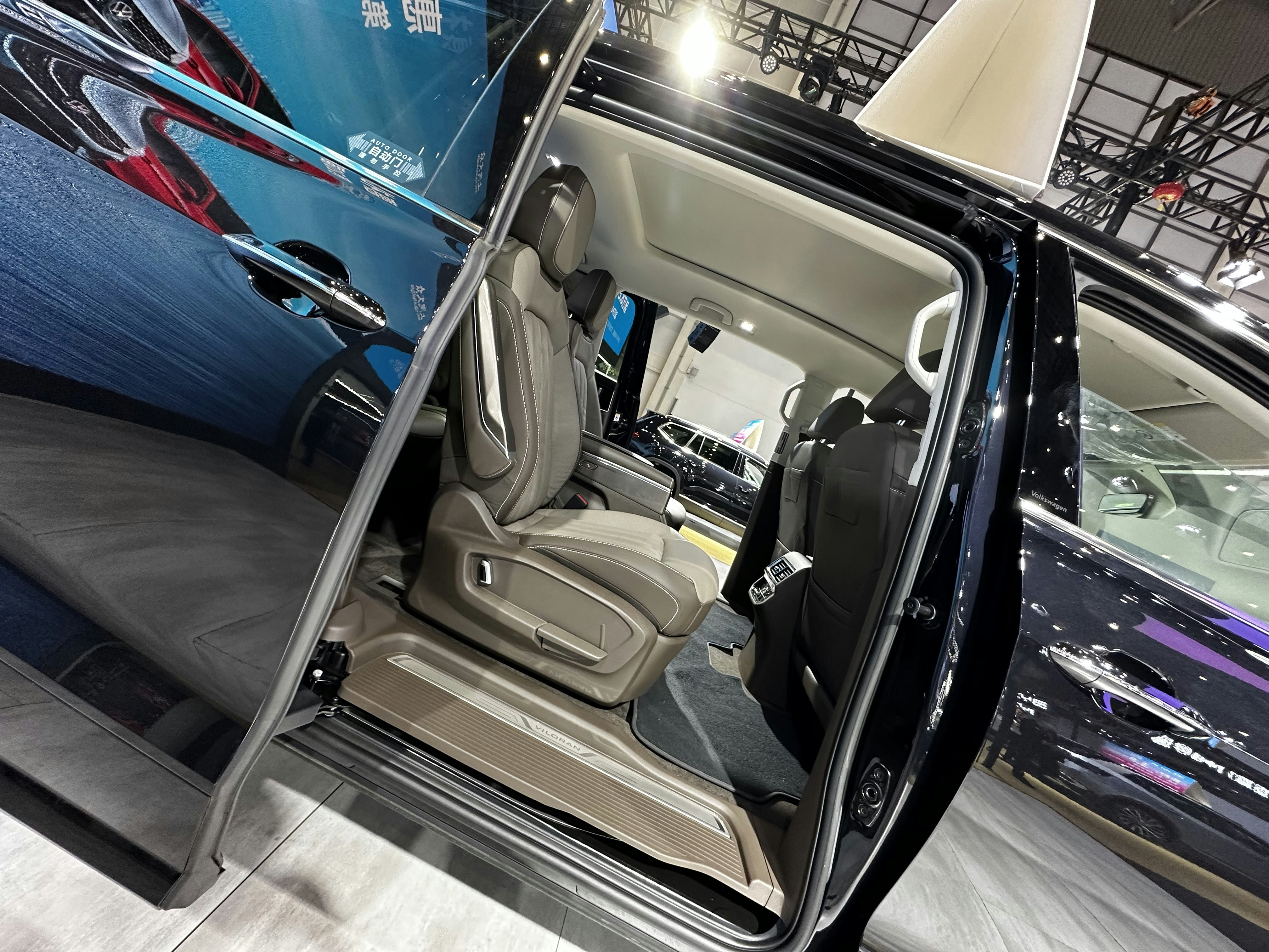 Interior of premium SUV after deep clean, dark leather seats, dim atmospheric lighting, clean surfaces, low-key mood