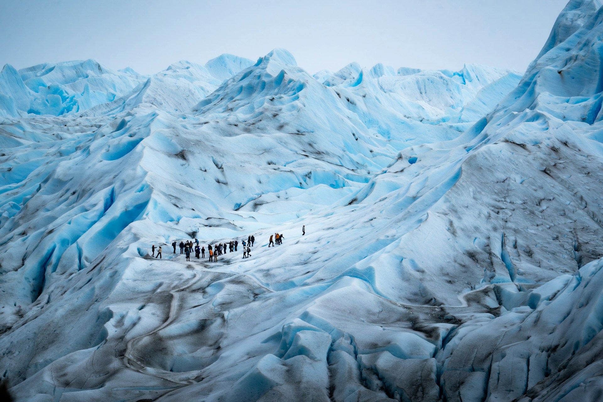 A group of people standing on top of a snow covered mountain