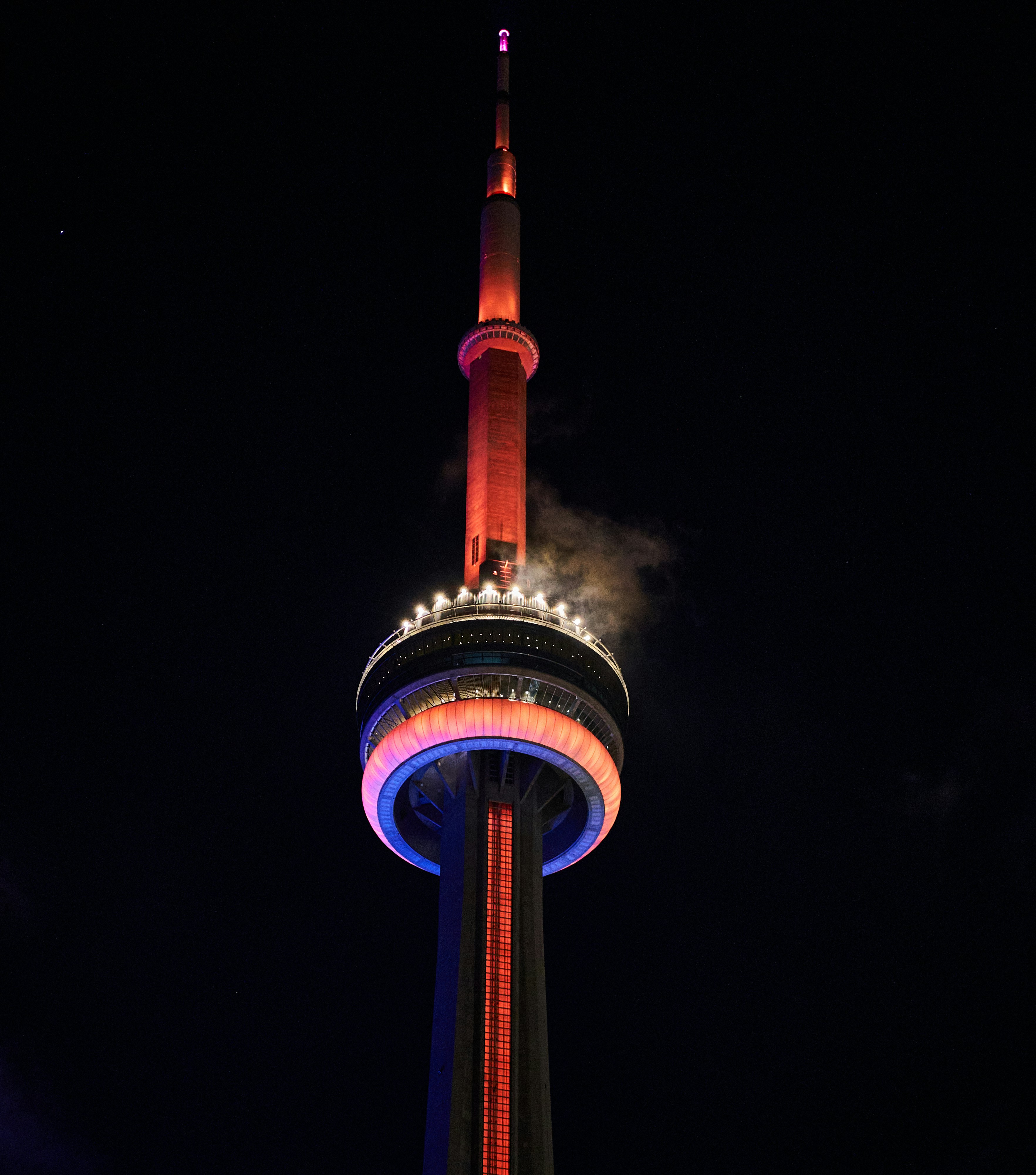 A very tall tower with a clock on it's side