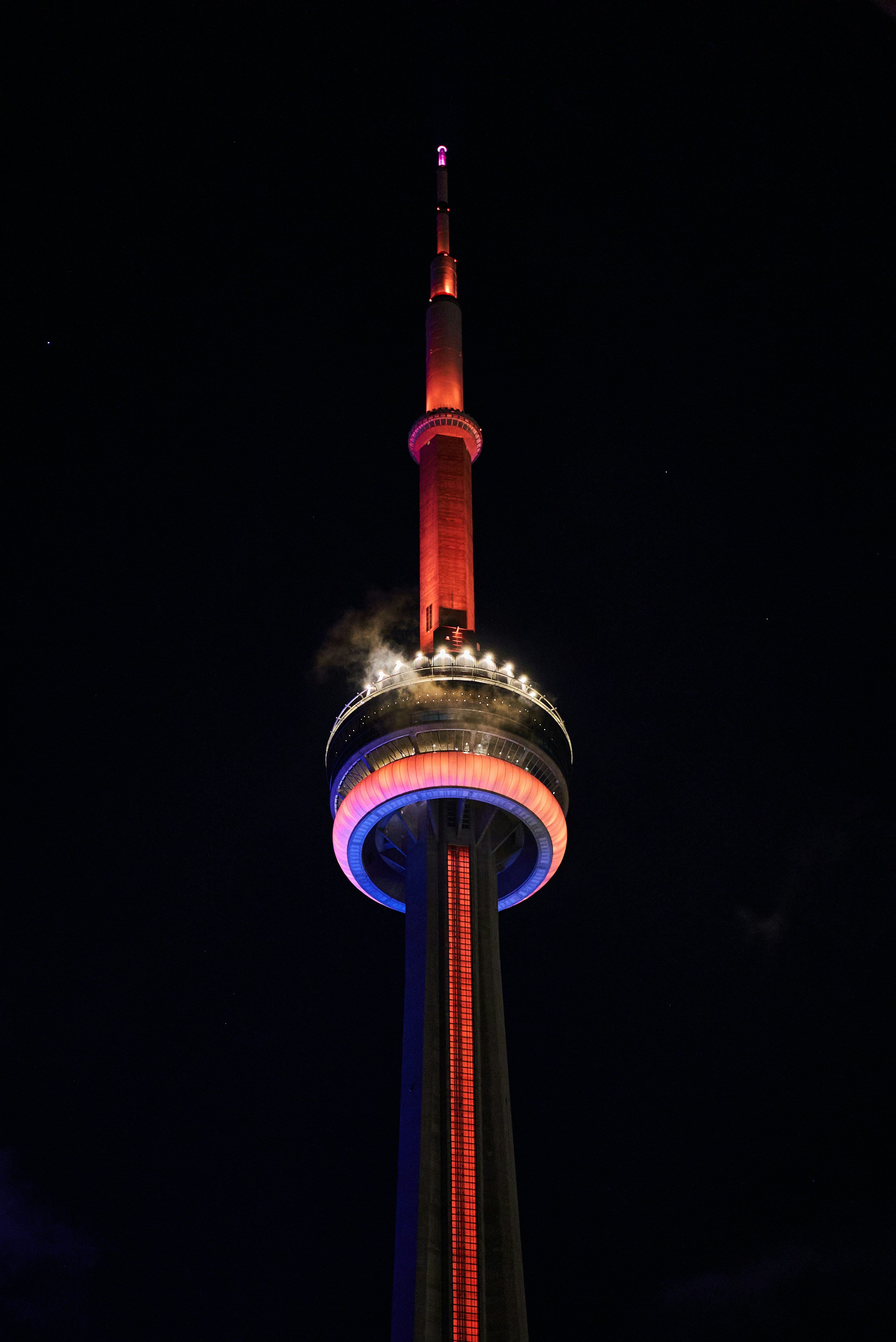 A very tall tower with a clock on it's side