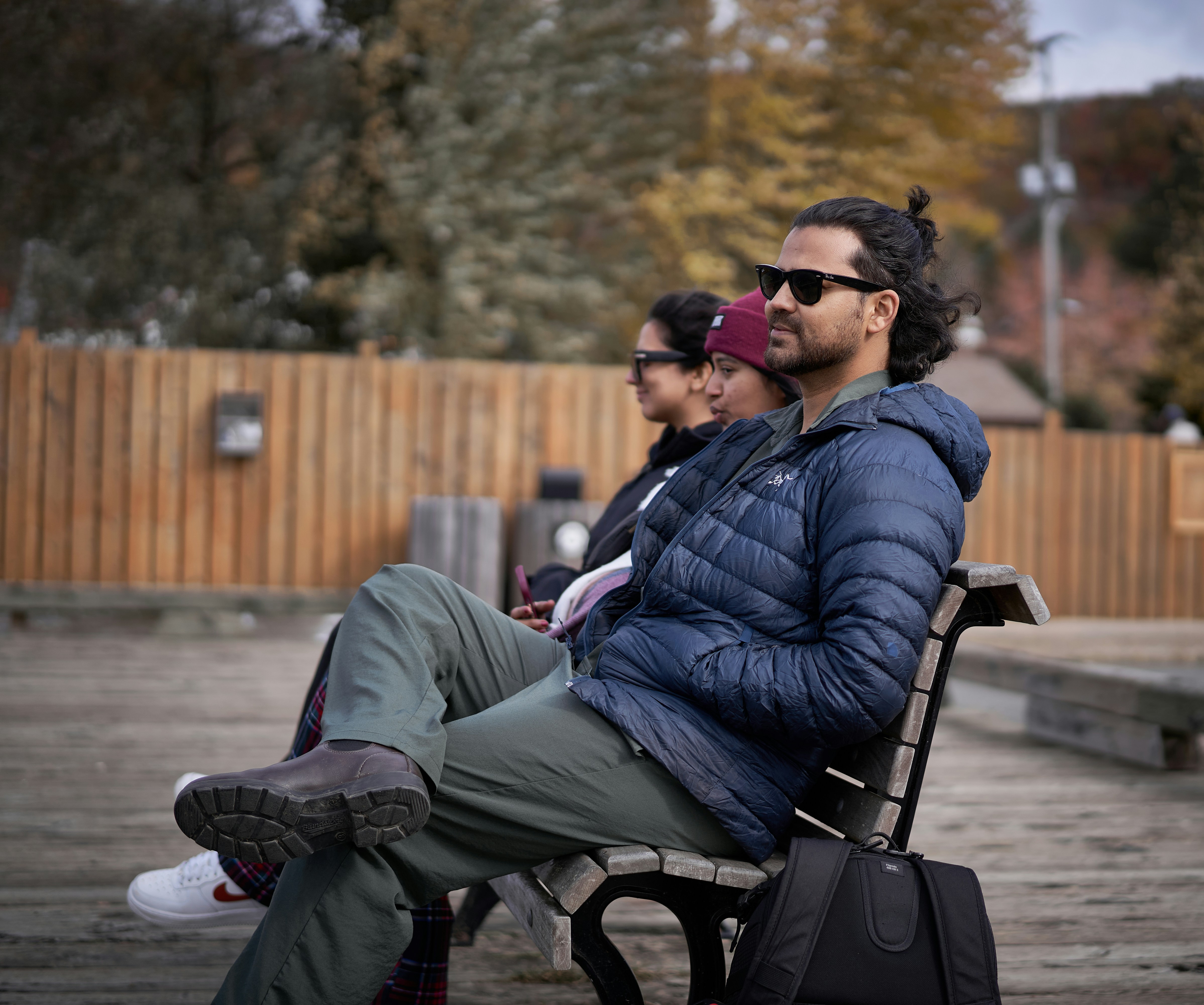A man sitting on a bench next to a woman