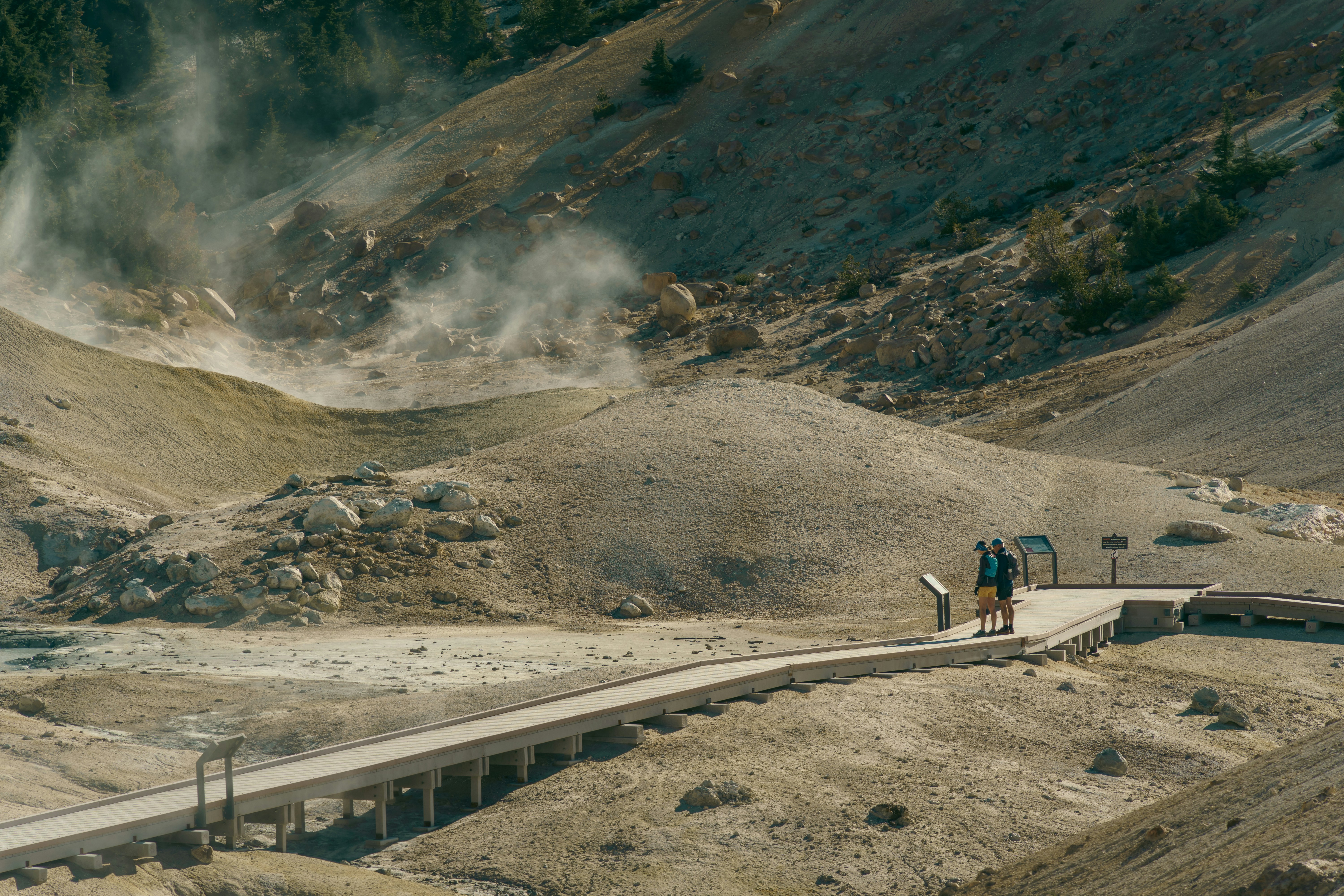 A group of people standing on top of a dirt hill