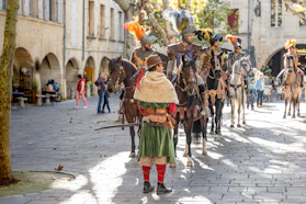 A group of people riding horses down a street