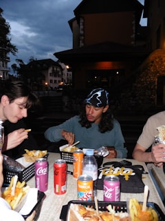 A group of people sitting around a table eating food
