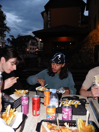A group of people sitting around a table eating food