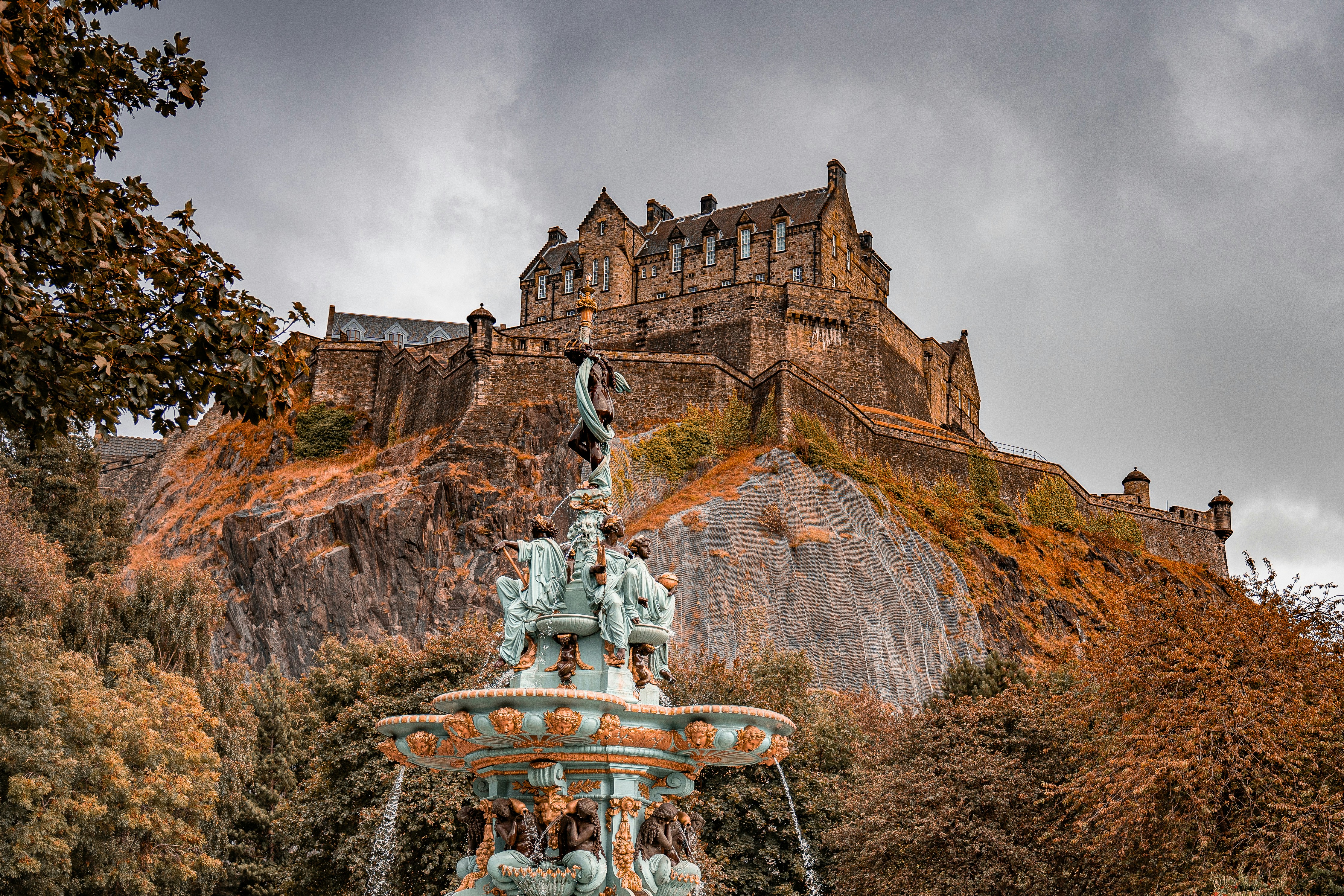 A fountain with a castle in the background