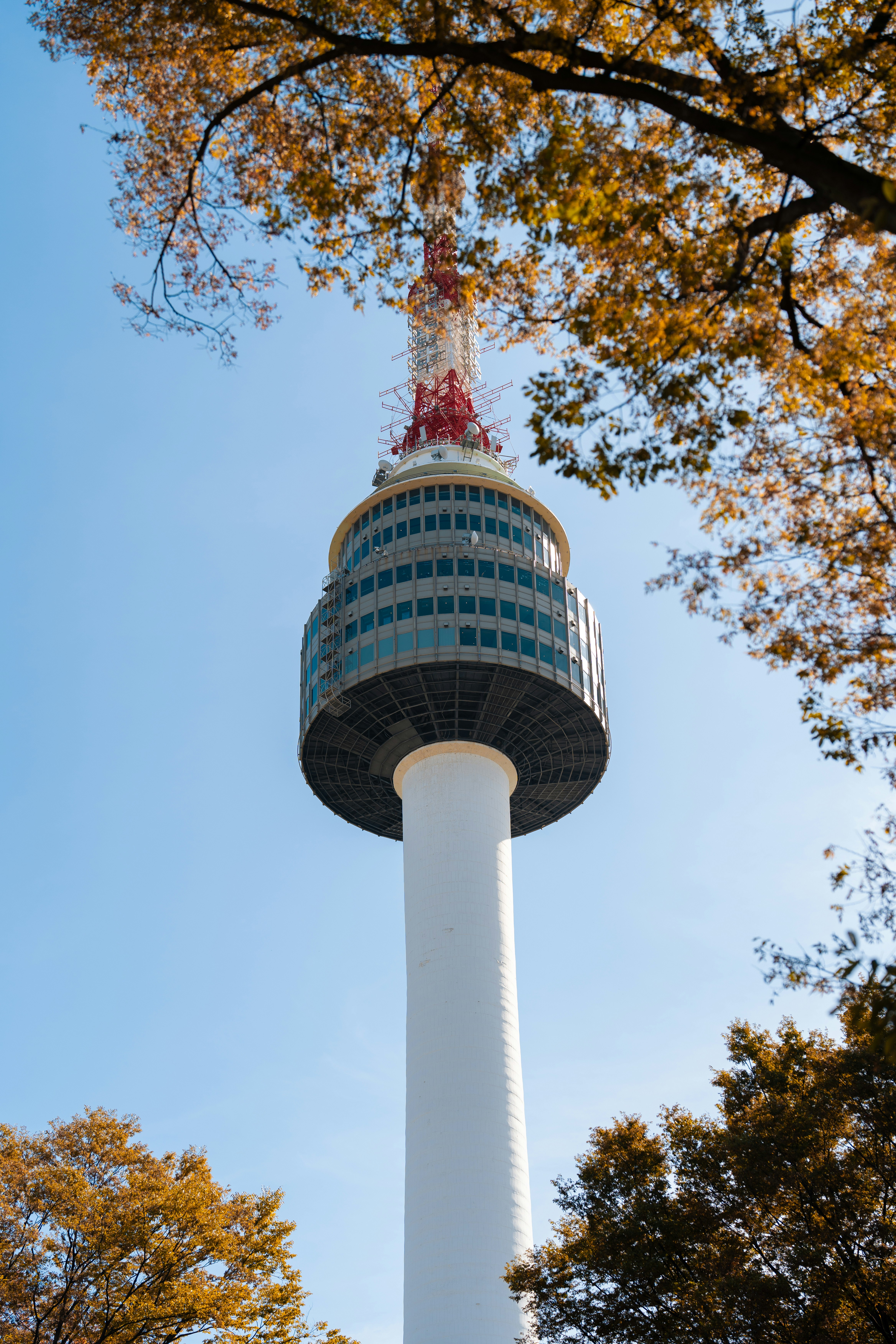 A tall white tower with a red top